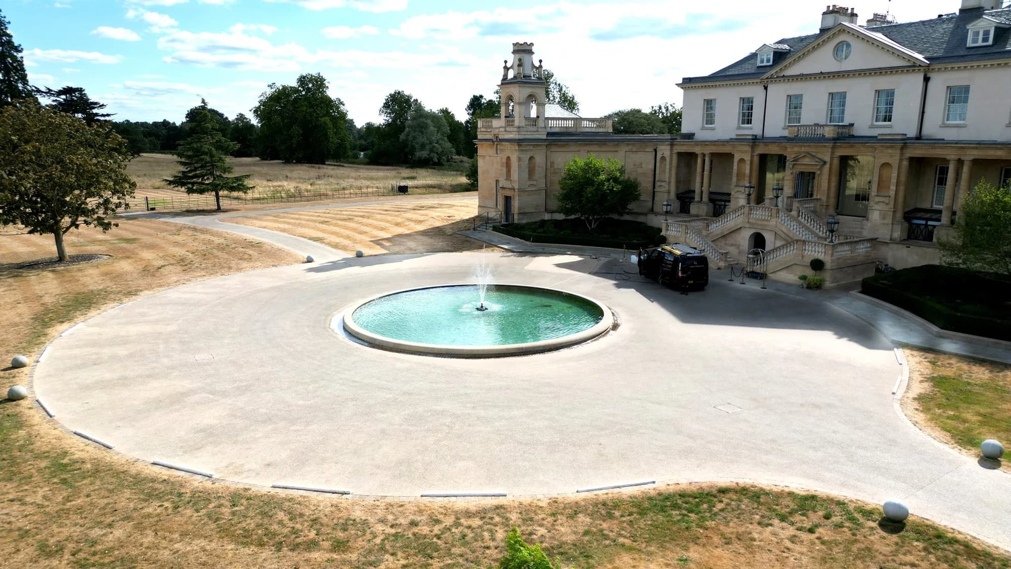 Drone view of the same forecourt and turning circle after cleaning, the surface pale and even