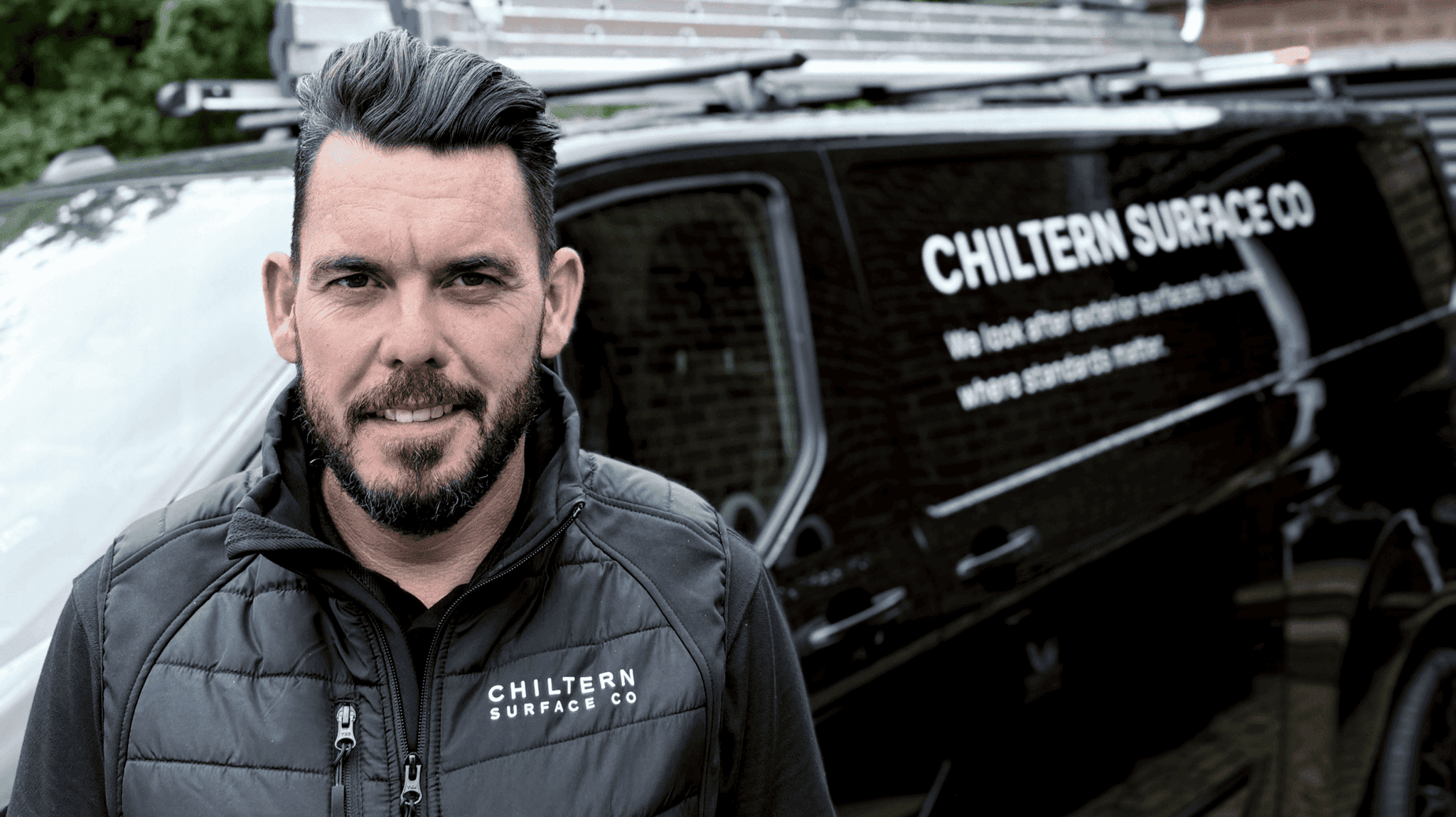 Jon McGrath, founder of Chiltern Surface Co, beside the company van