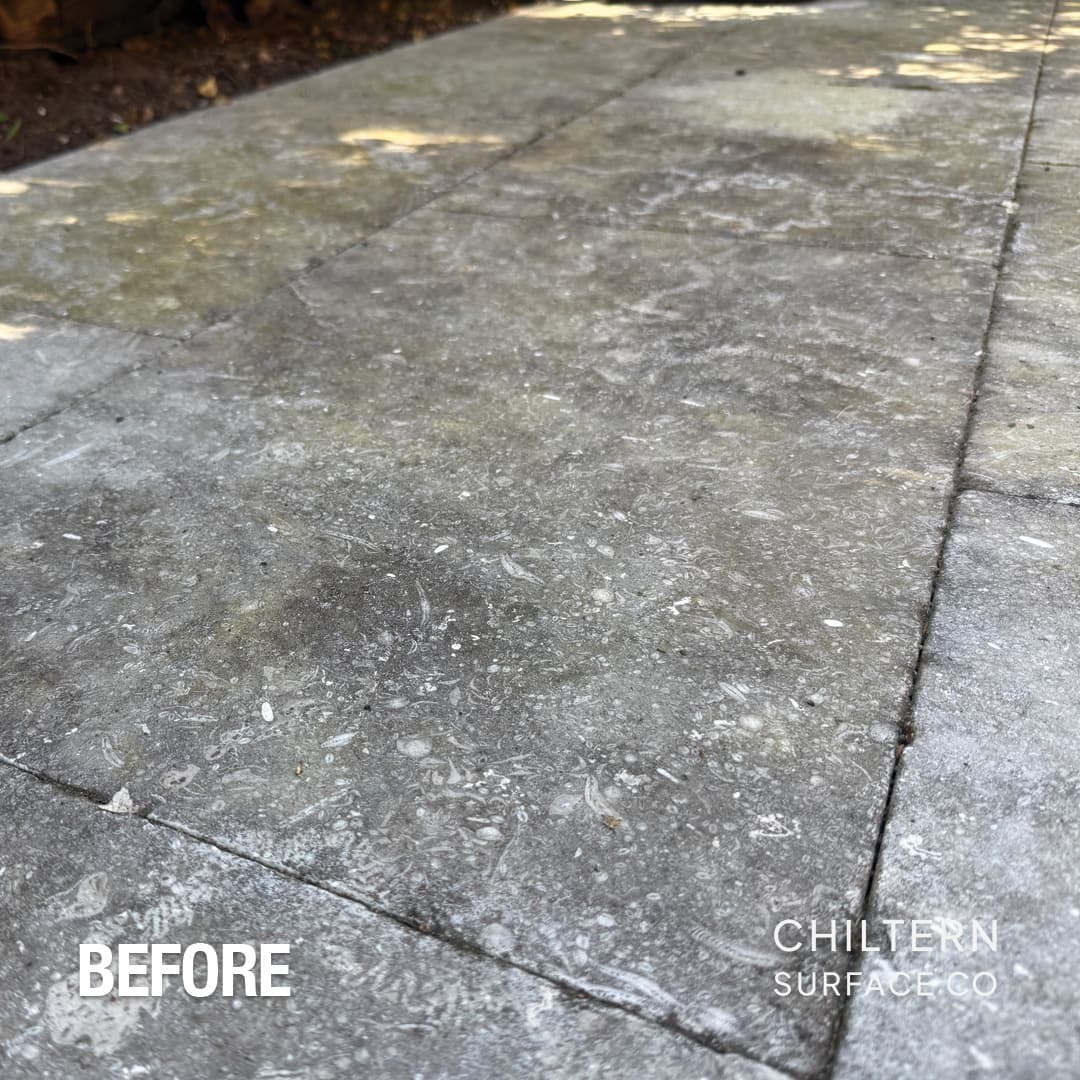 Limestone paving covered in black spot lichen before specialist treatment