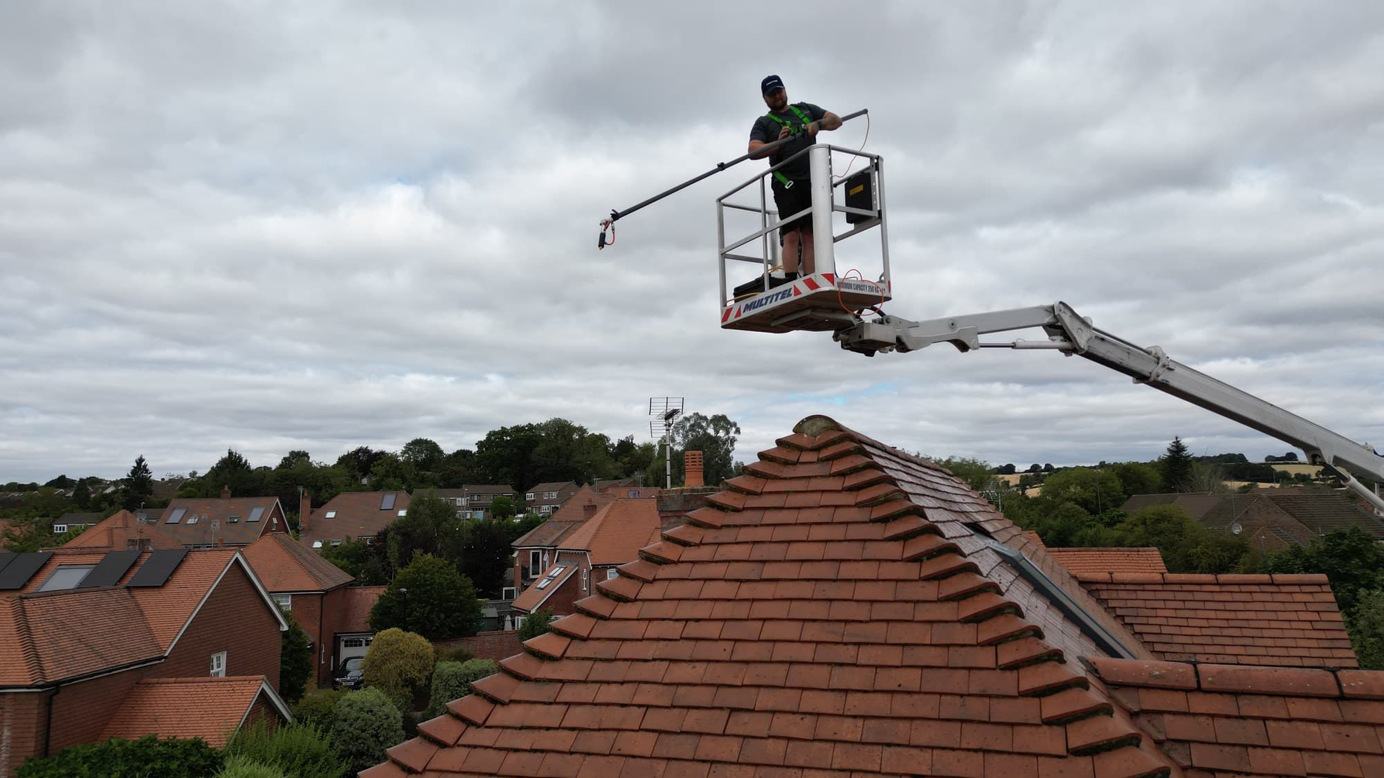 Chiltern Surface Co operative cleaning a tiled roof from a raised access platform