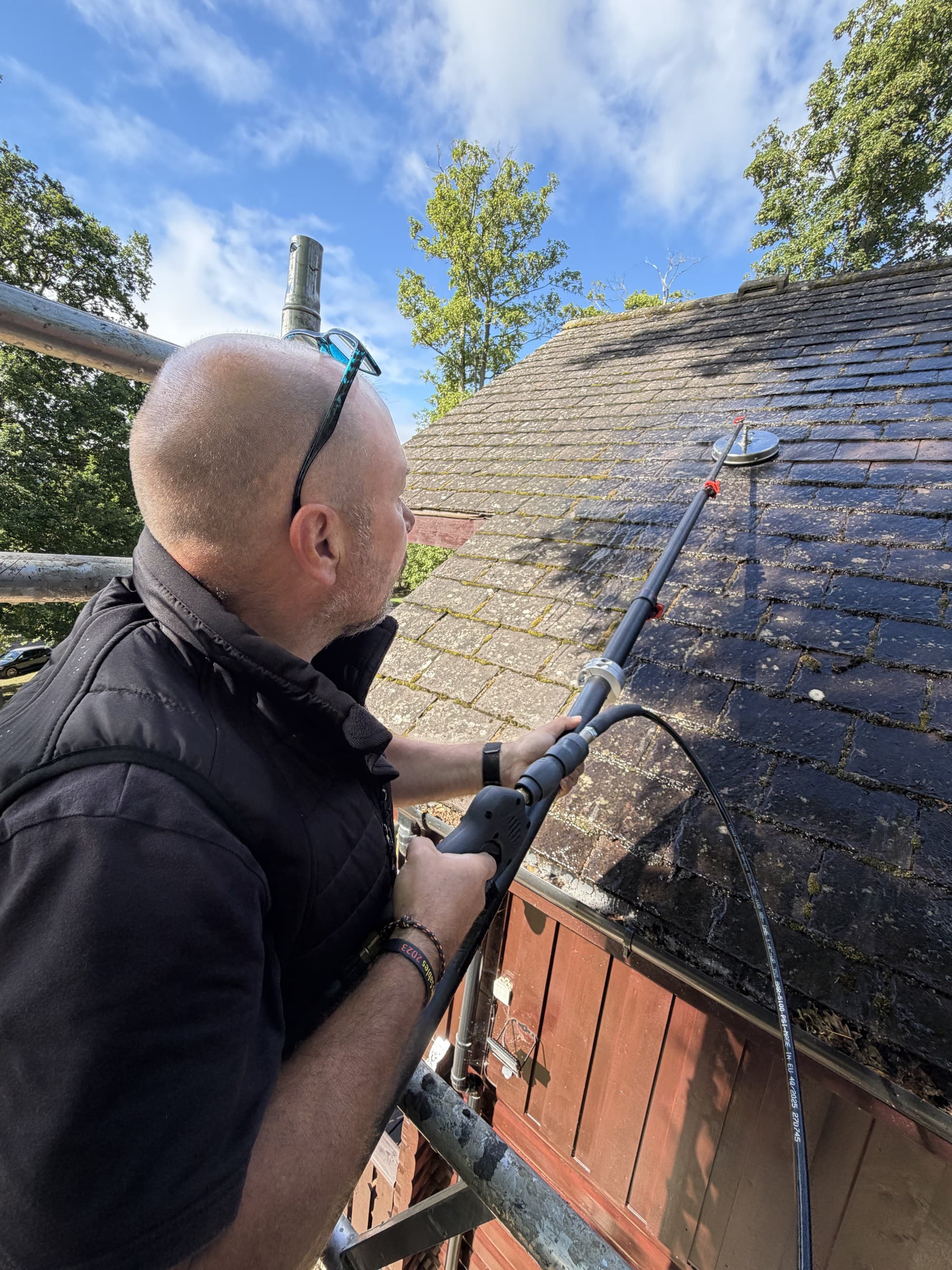 Chiltern Surface Co operative soft washing a tiled roof at low pressure