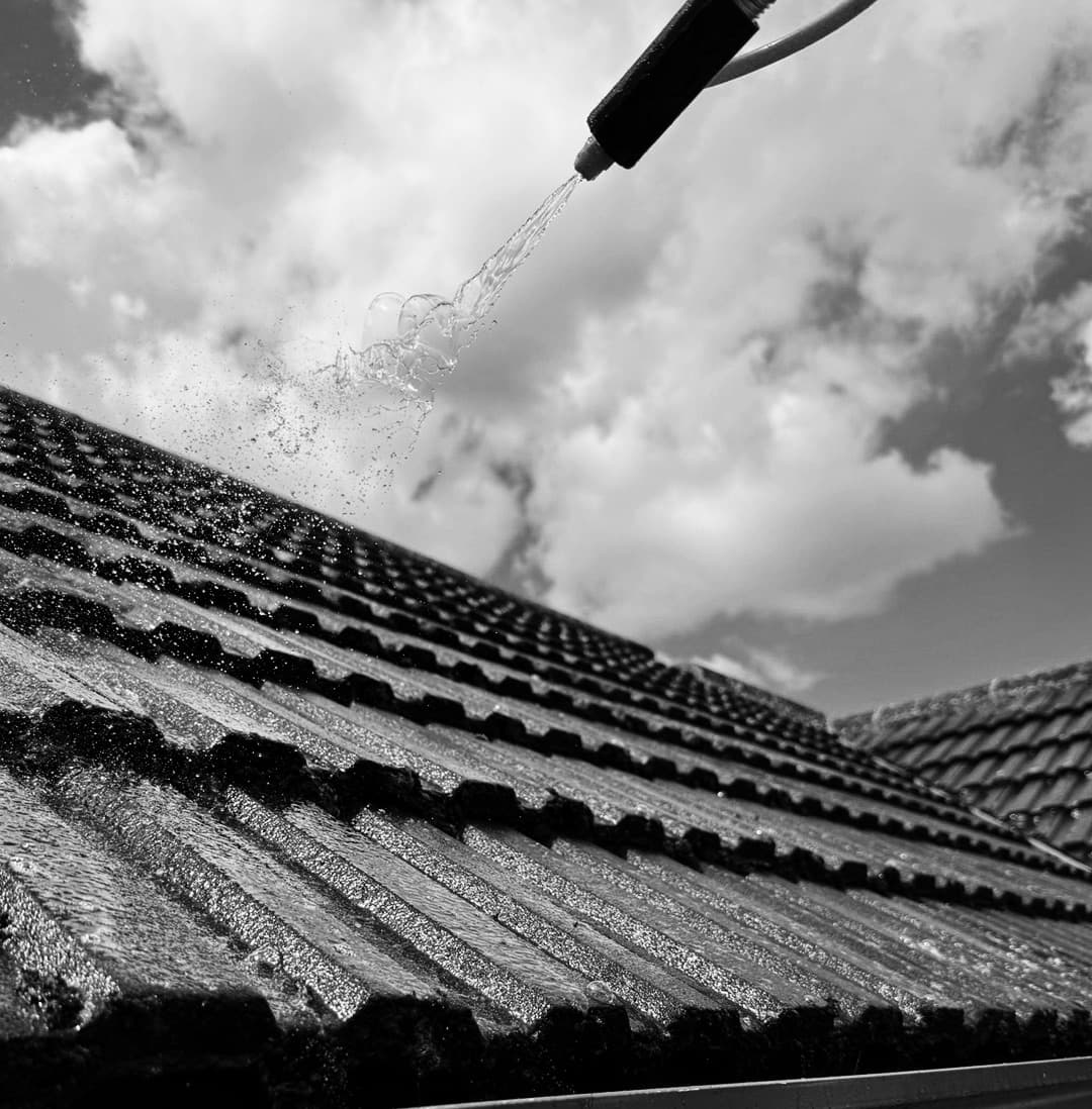 Tiled roof being soft washed and Chiltern EverGuard™ treated during professional moss removal