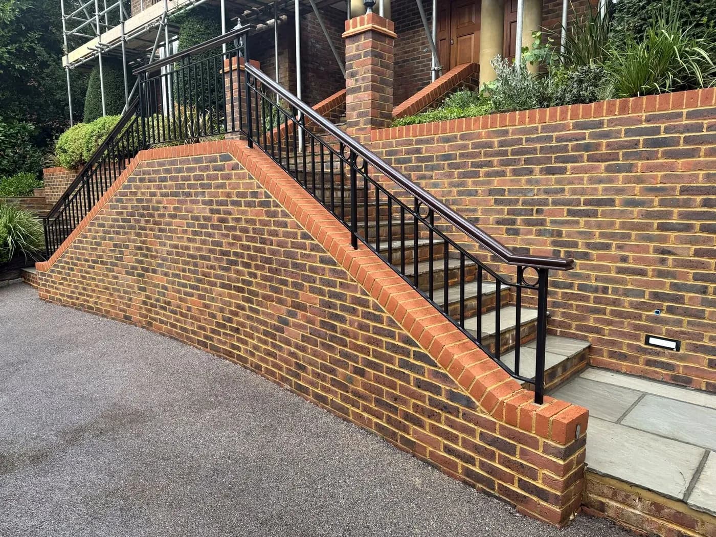 Brick retaining wall after soft washing, the black algae gone from the face