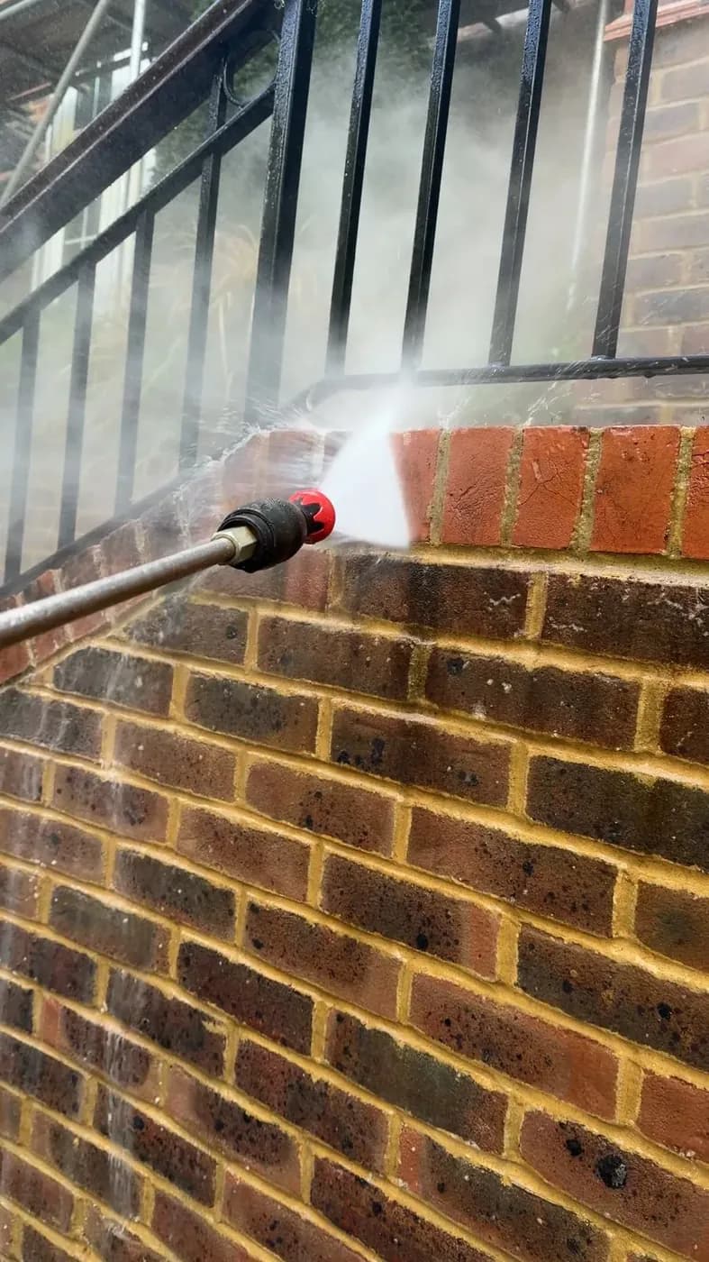 Low-pressure rinse of a brick coping after the soft wash solution has done its work