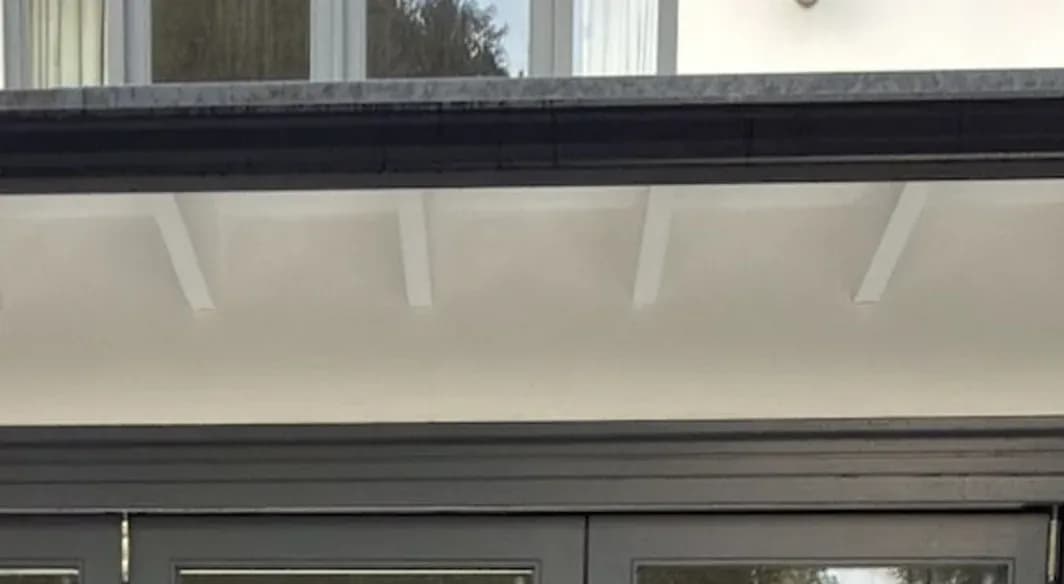 Timber soffit and rafters after soft washing, clean and free of cobwebs