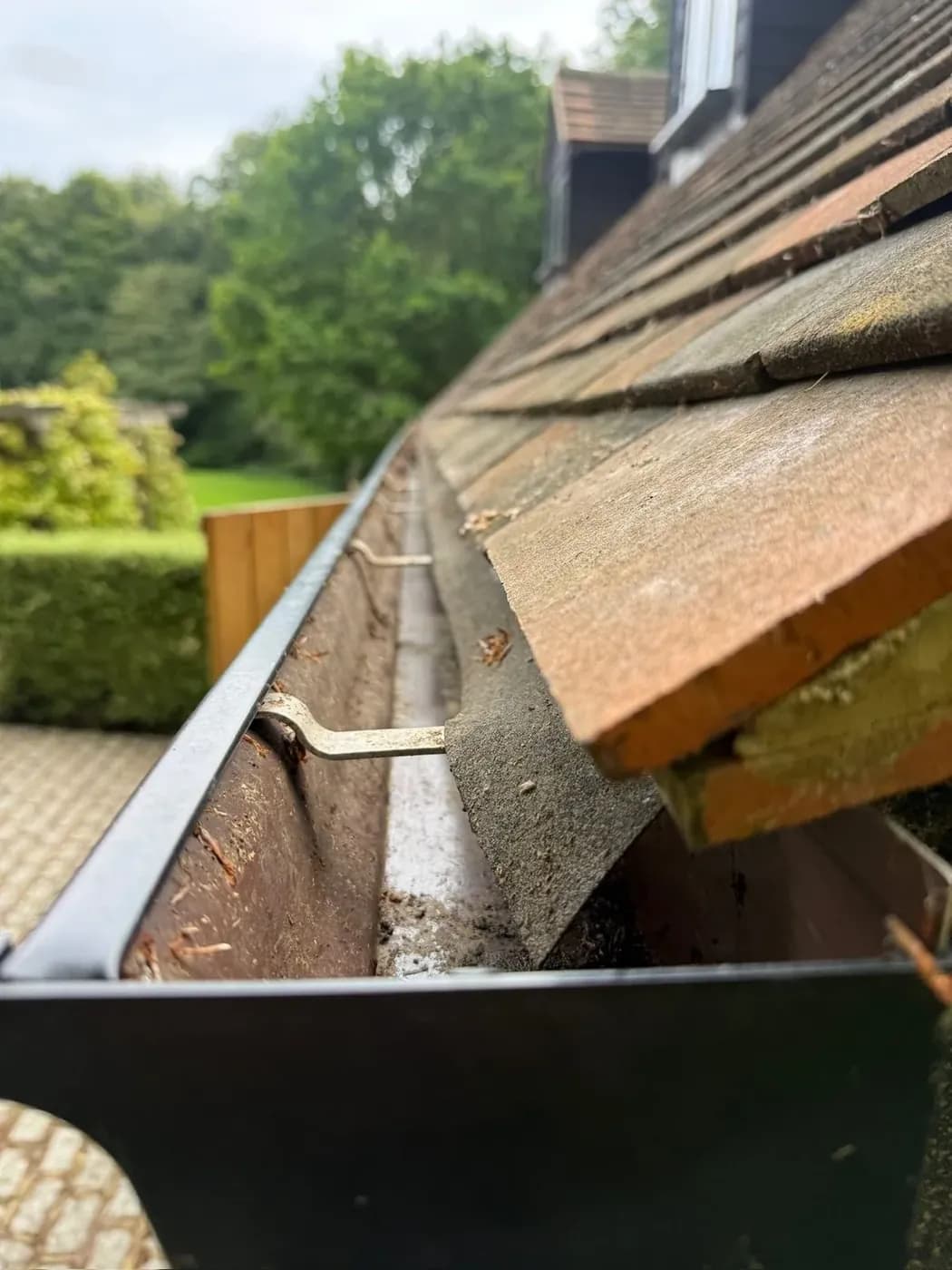 Clean, clear gutter after professional gutter cleaning, the channel empty to the outlet