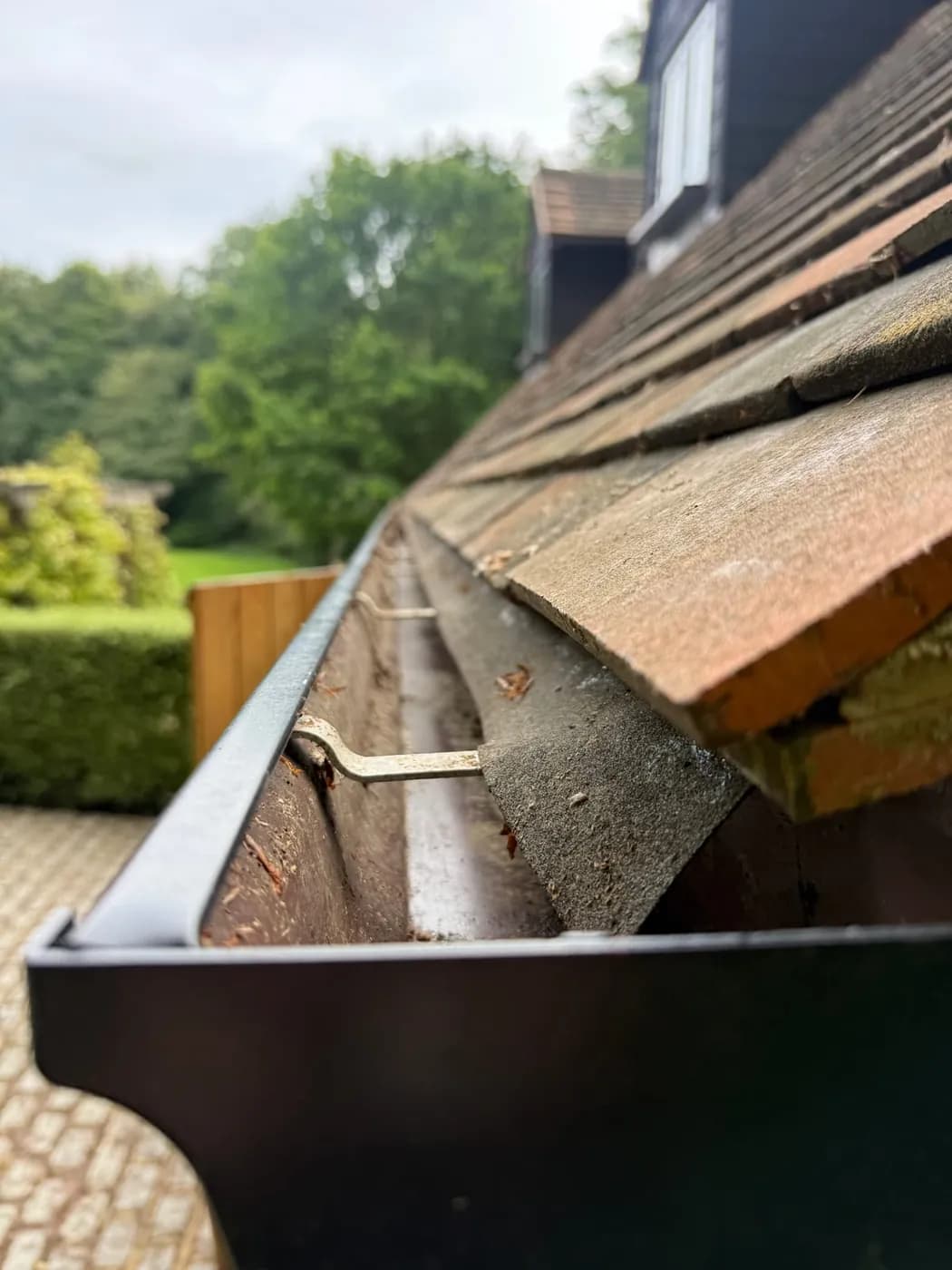 Gutter after cleaning, the channel clear of leaves and silt