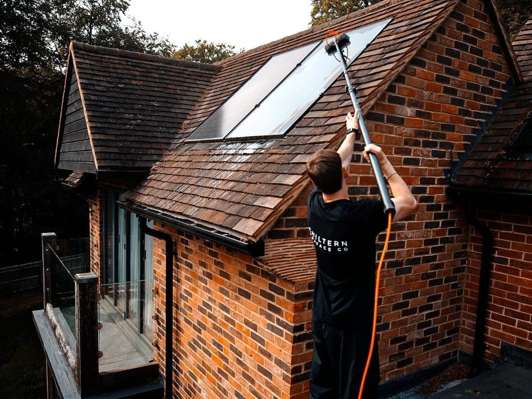 Chiltern Surface Co operative cleaning roof-mounted solar panels with a water-fed pole