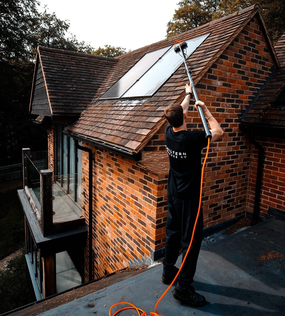Chiltern Surface Co operative cleaning roof-mounted solar panels with a water-fed pole