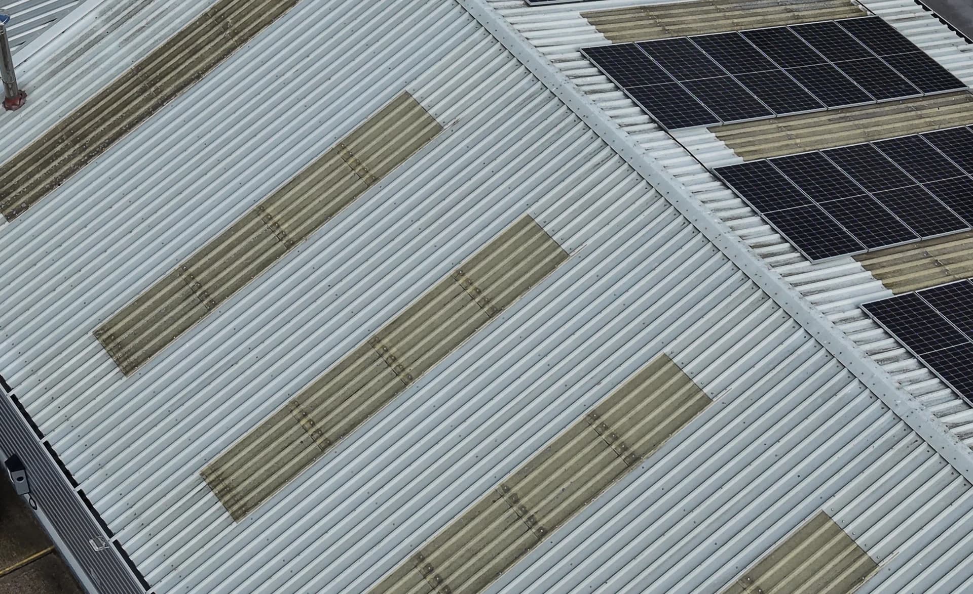 Aerial view of a roof edge with translucent rooflights and rooftop panels