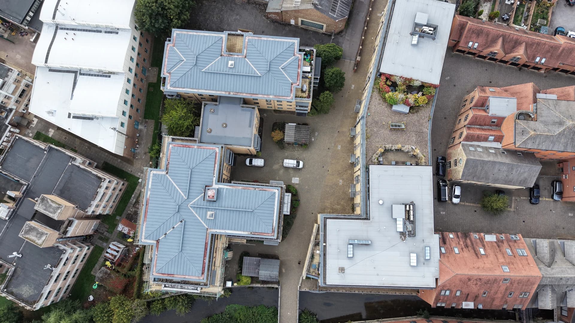 Overhead drone view of courtyard and blocks, near duplicate of 003.