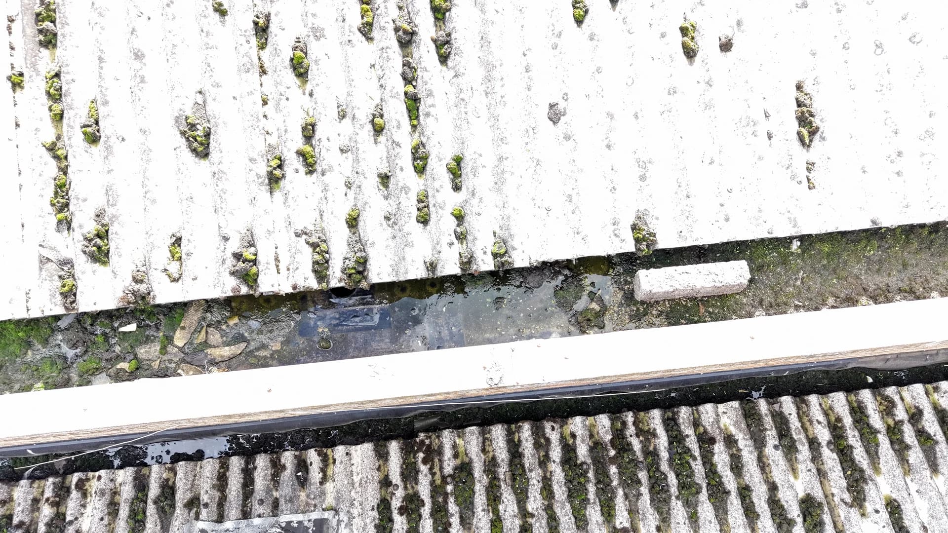 Top-down aerial view of a gutter channel between two roof slopes