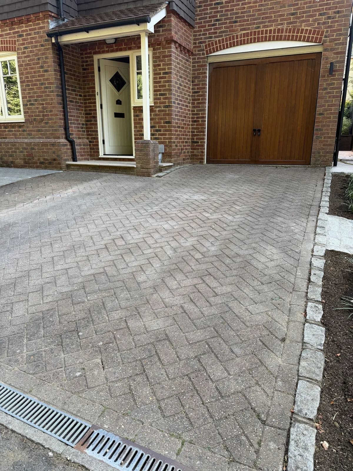 The weathered block paved driveway and the front of the house in Hazlemere before cleaning