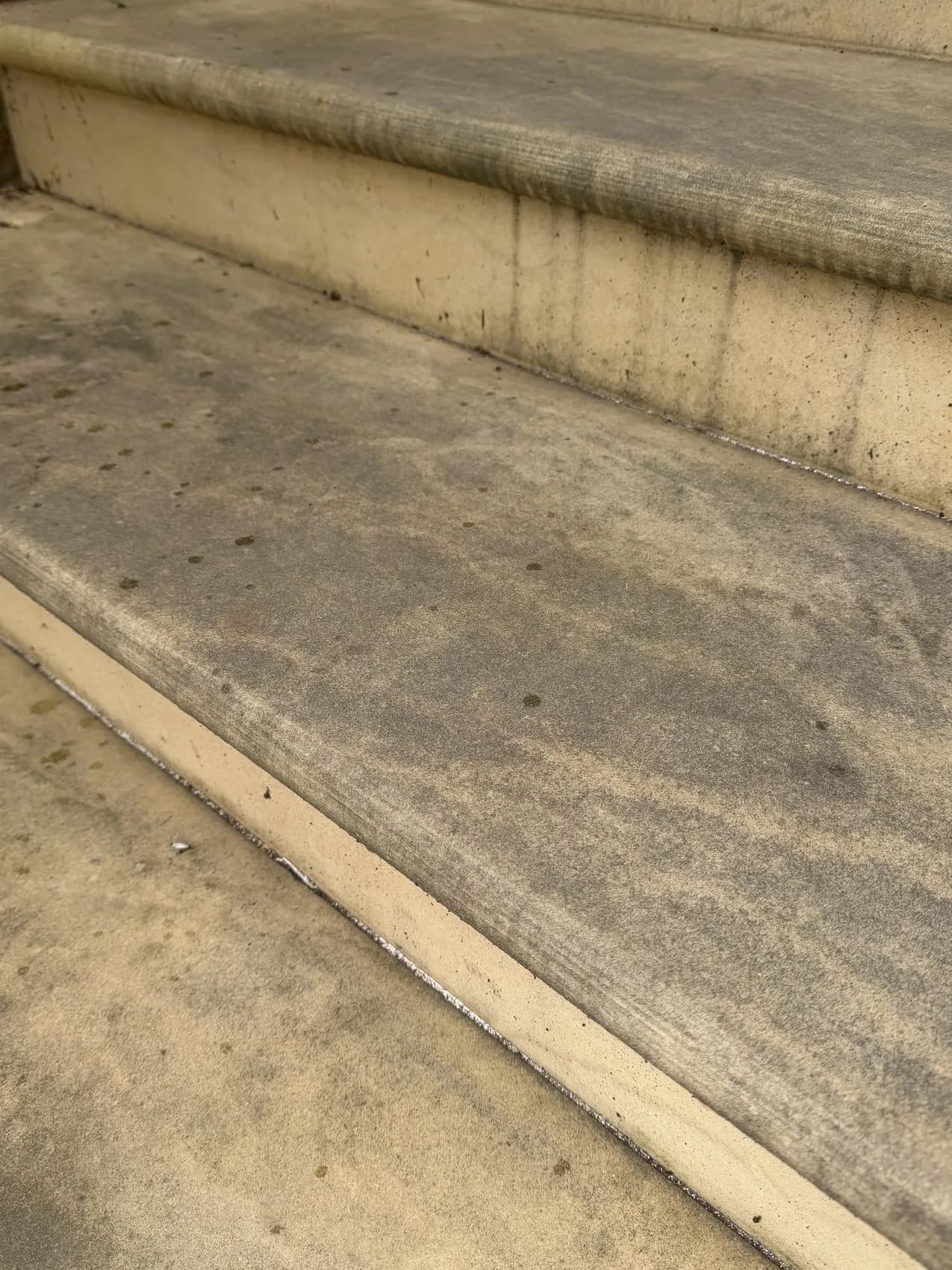 Black spot and weathering on Indian sandstone steps before cleaning, High Wycombe