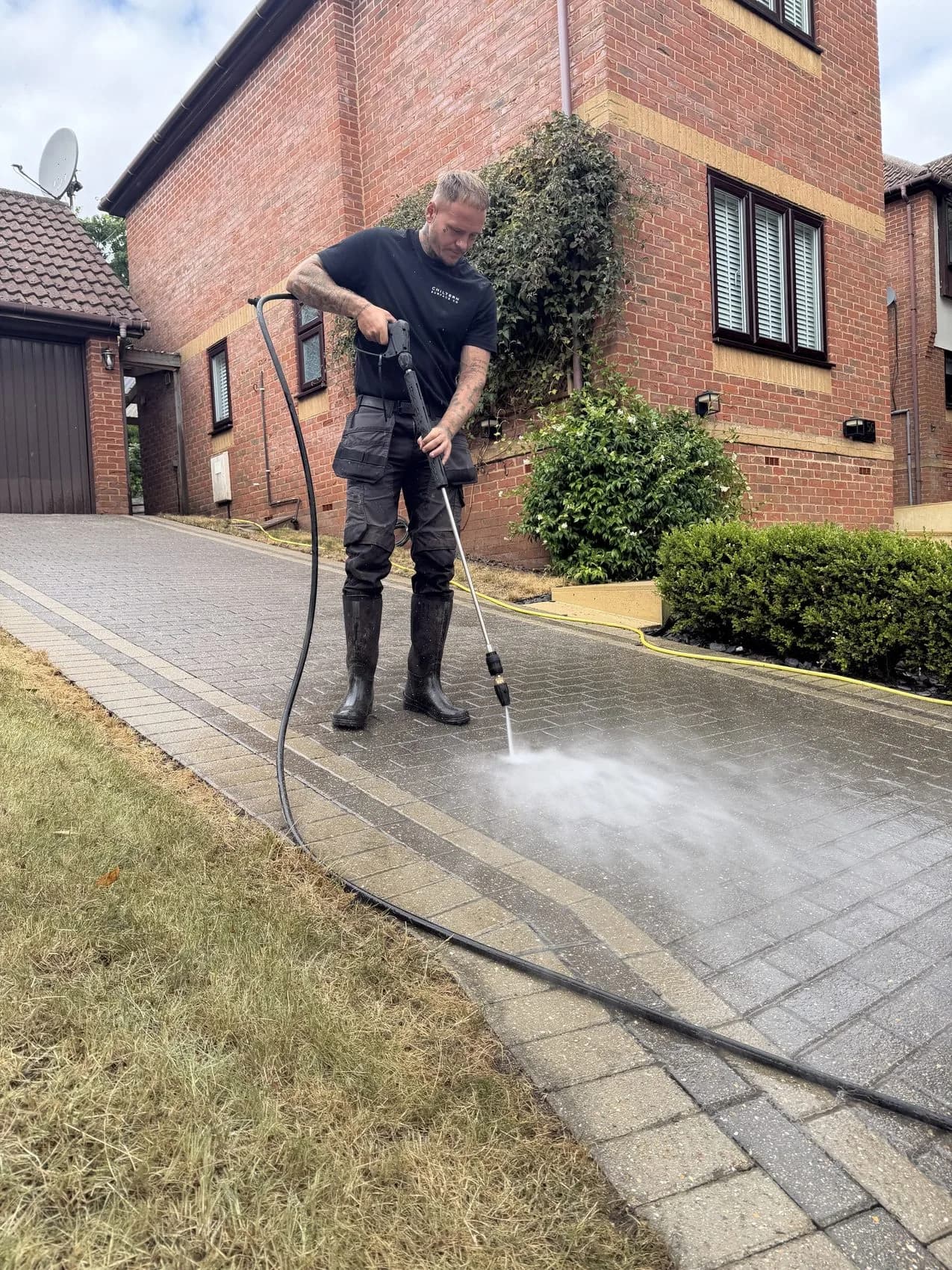 Block paved driveway deep cleaning in High Wycombe — unwashed paving beside the first pass