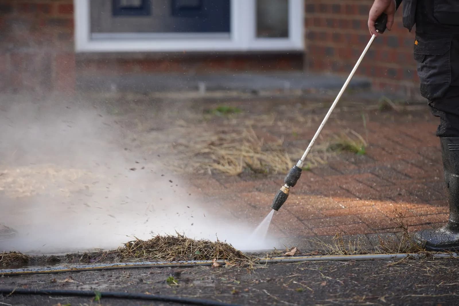 Lance stripping organic growth out of the block paving joints