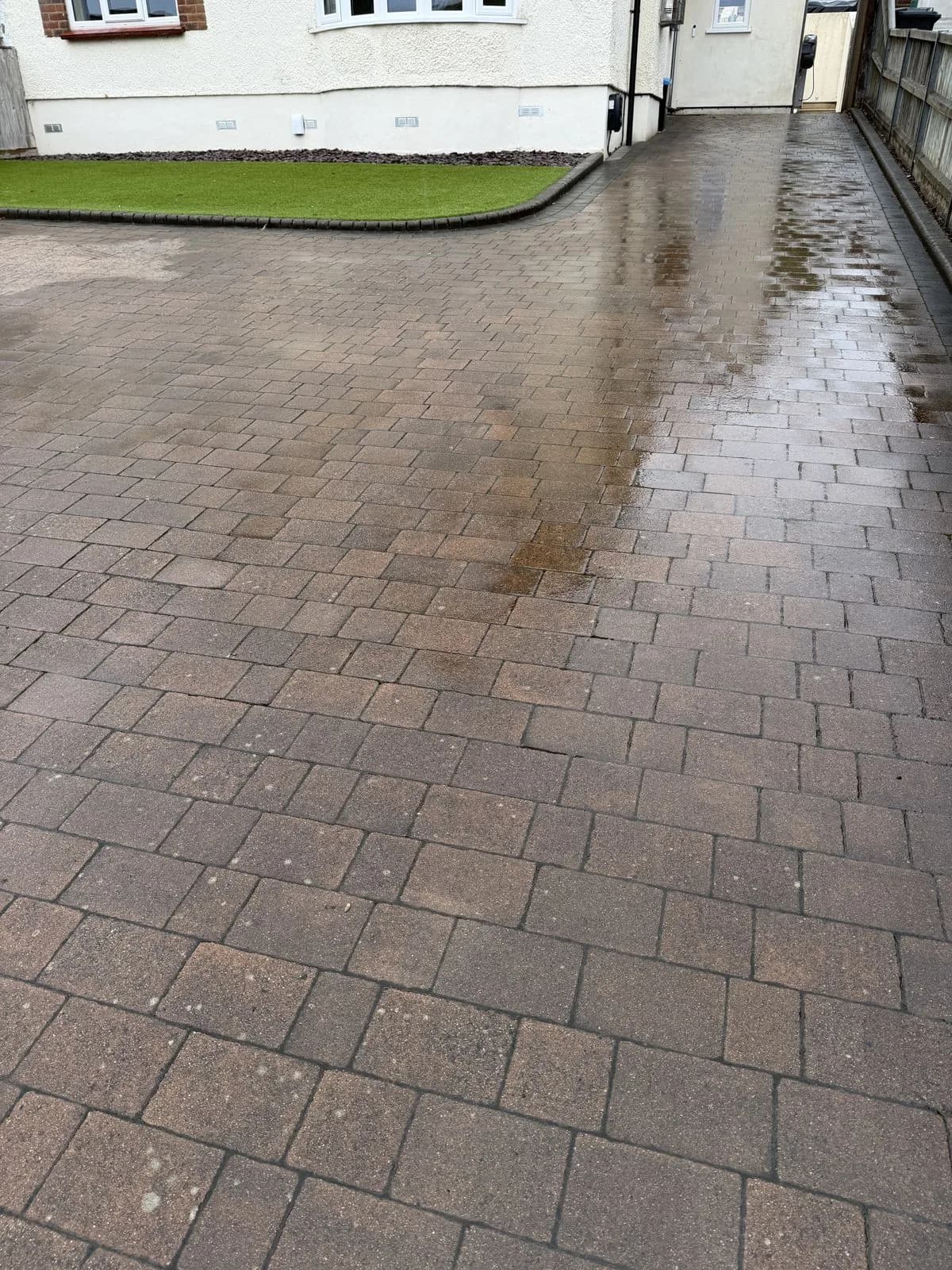 Block paved driveway in High Wycombe before restoration, dulled by lichen, black spot and organic growth