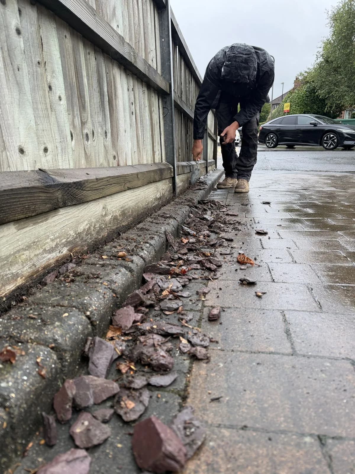 Chiltern Surface Co technician removing the slate edging from the block paved driveway piece by piece