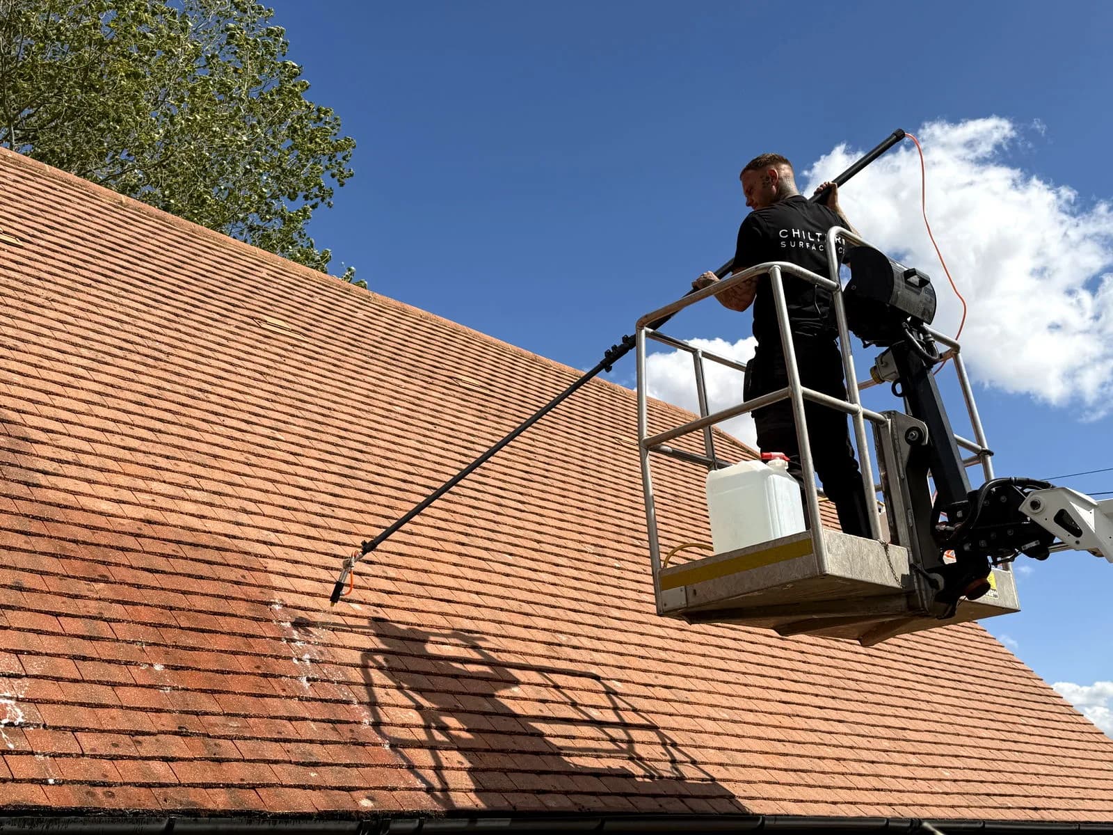Chiltern Surface Co technician applying Chiltern EverGuard™ biocide treatment to the cleaned clay tiles from the basket