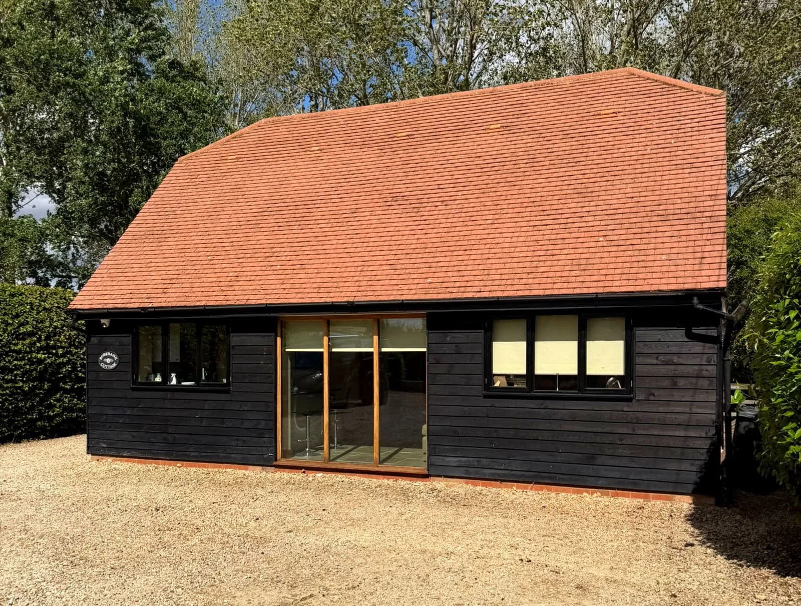 The same view of the annex in Aylesbury after cleaning, the clay tile roof back to warm terracotta