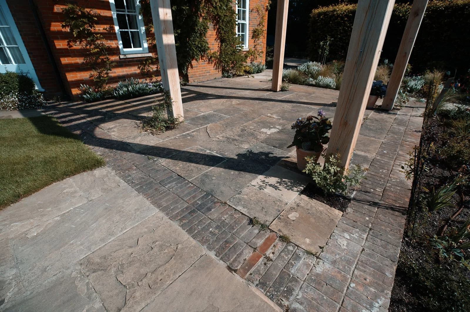 The sandstone patio and pergola terrace in Henley-on-Thames before cleaning