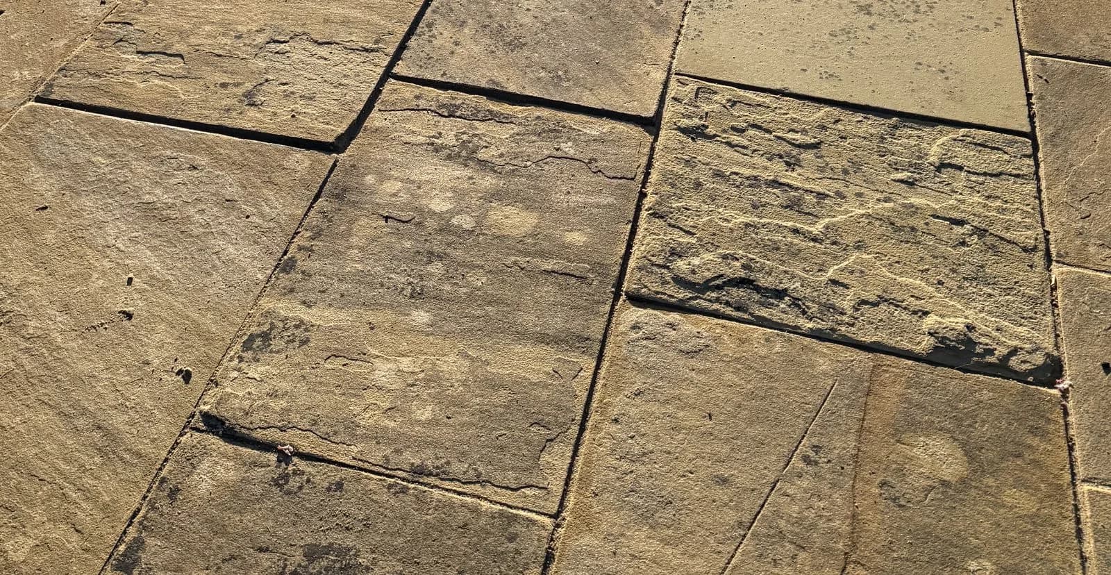 Close-up of the smooth new jointing between the Indian sandstone slabs after repointing