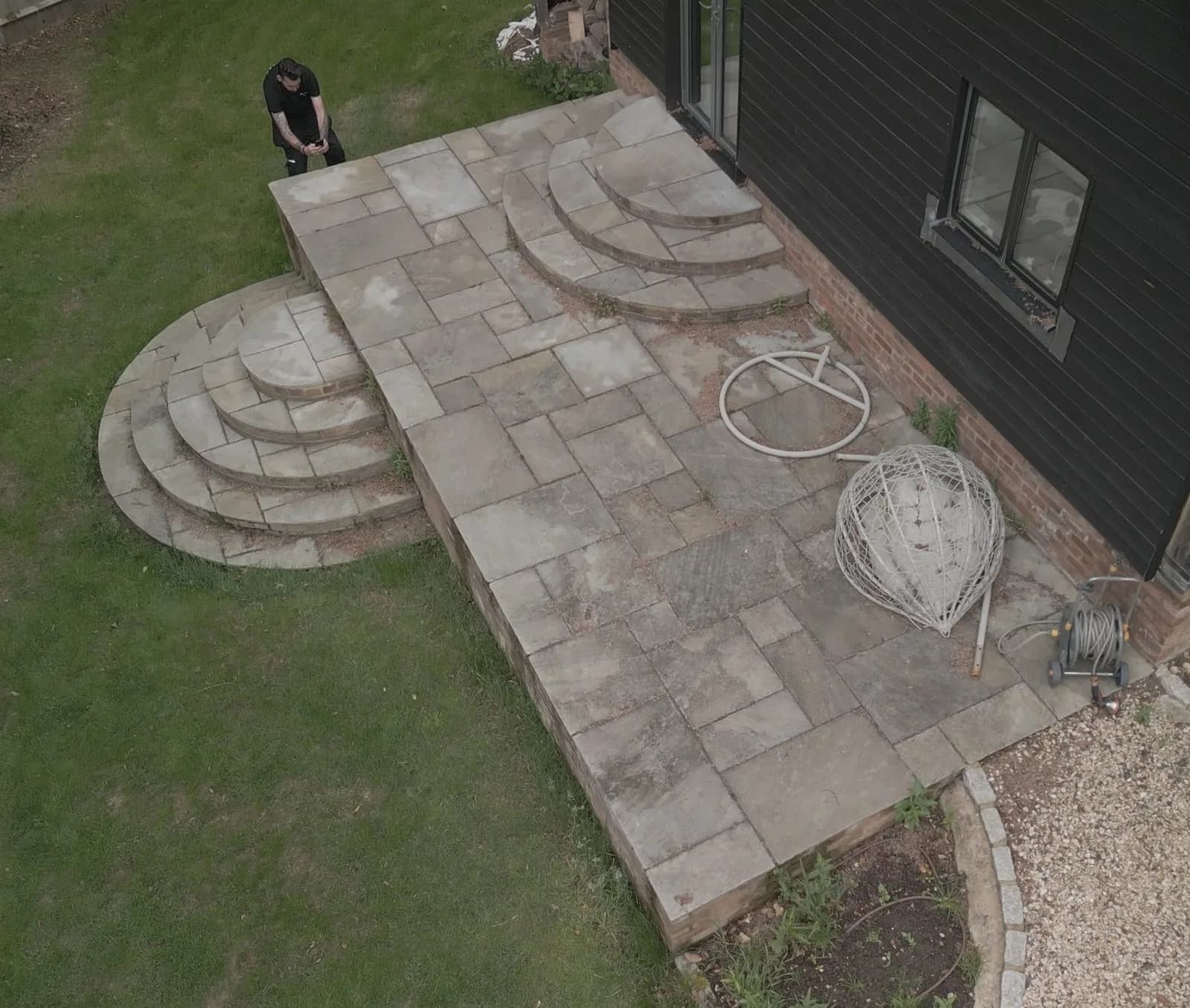 Weathered natural stone patio in Marlow from above before cleaning, moss and algae in the joints