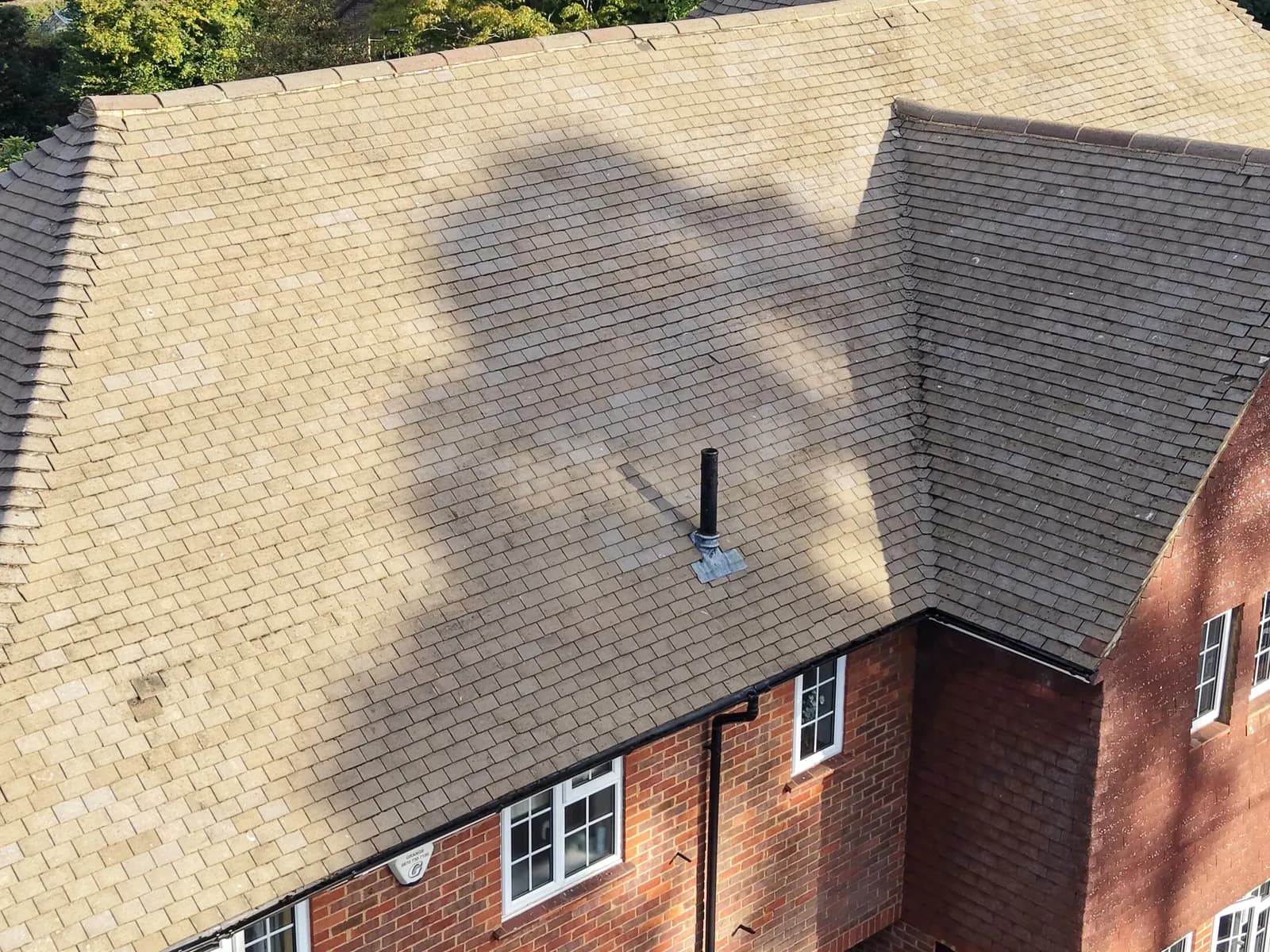 The clean concrete tile roof in Great Missenden cropped close, hips and ridges sharp after cleaning