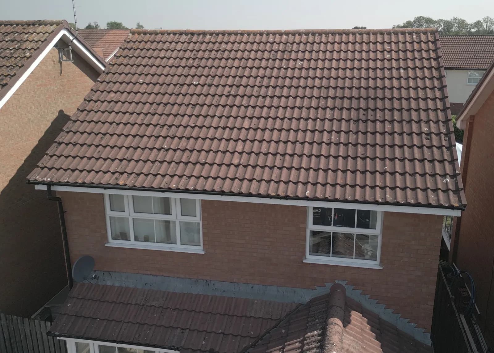 The rear roof of the Aylesbury home before cleaning, dark with moss and algae, seen from the drone
