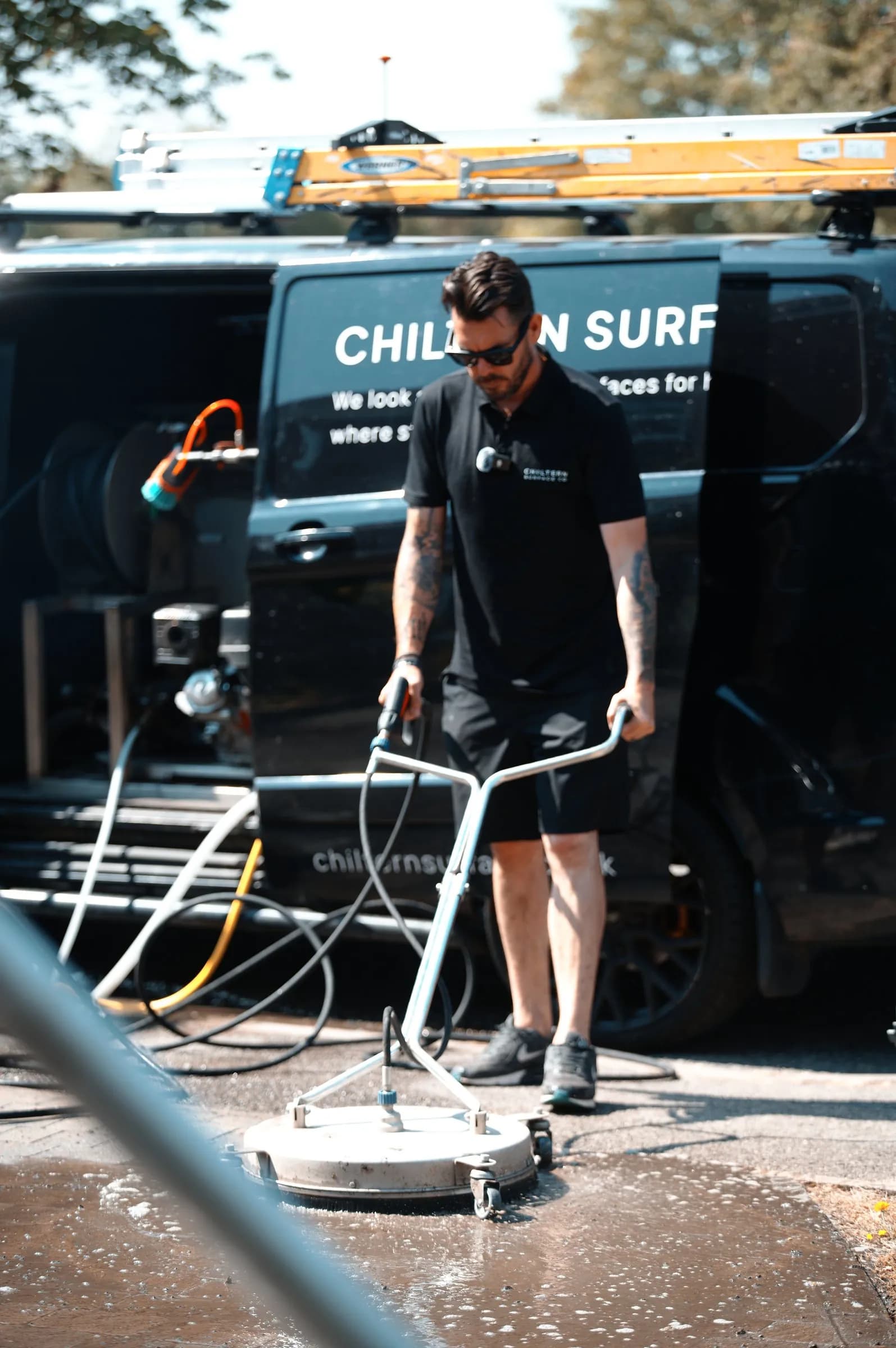 Chiltern Surface Co technician deep cleaning a block paved driveway in Aylesbury with a rotary surface cleaner