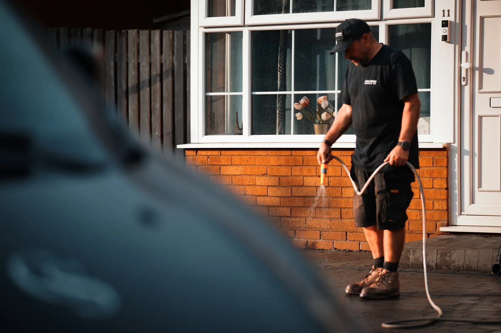 Chiltern Surface Co technician activating the polymeric sand with a fine water mist