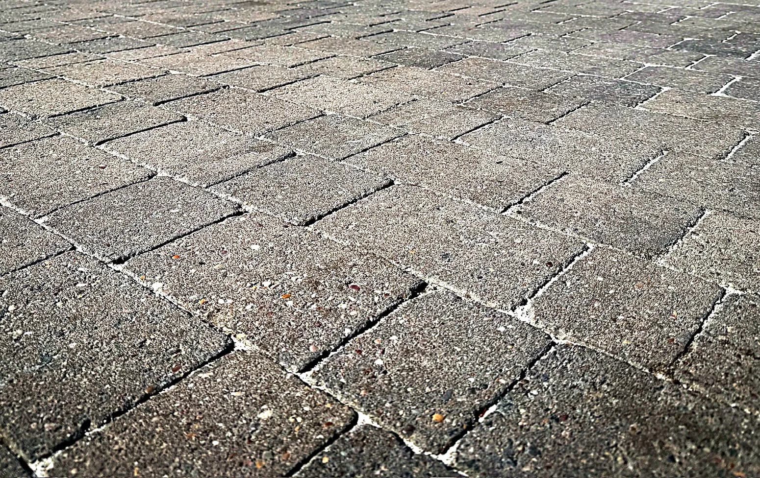 The cleaned block paved driveway in Aylesbury with new polymeric sand joints, seen low across the paving