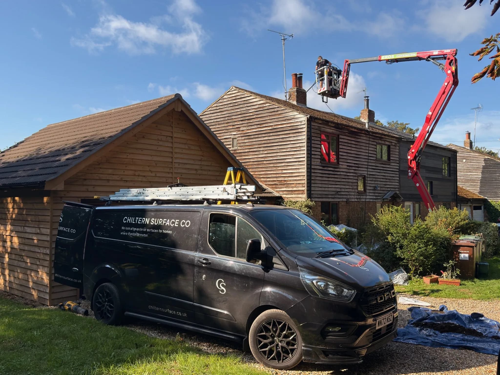 Chiltern Surface Co van and spider lift set up beside the cottage for roof moss removal in Henley-on-Thames