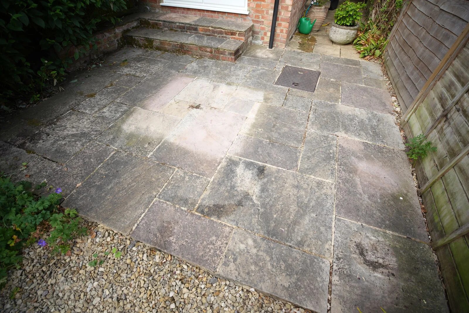 Sandstone patio in Oxford before cleaning, blackened by established black spot and organic growth
