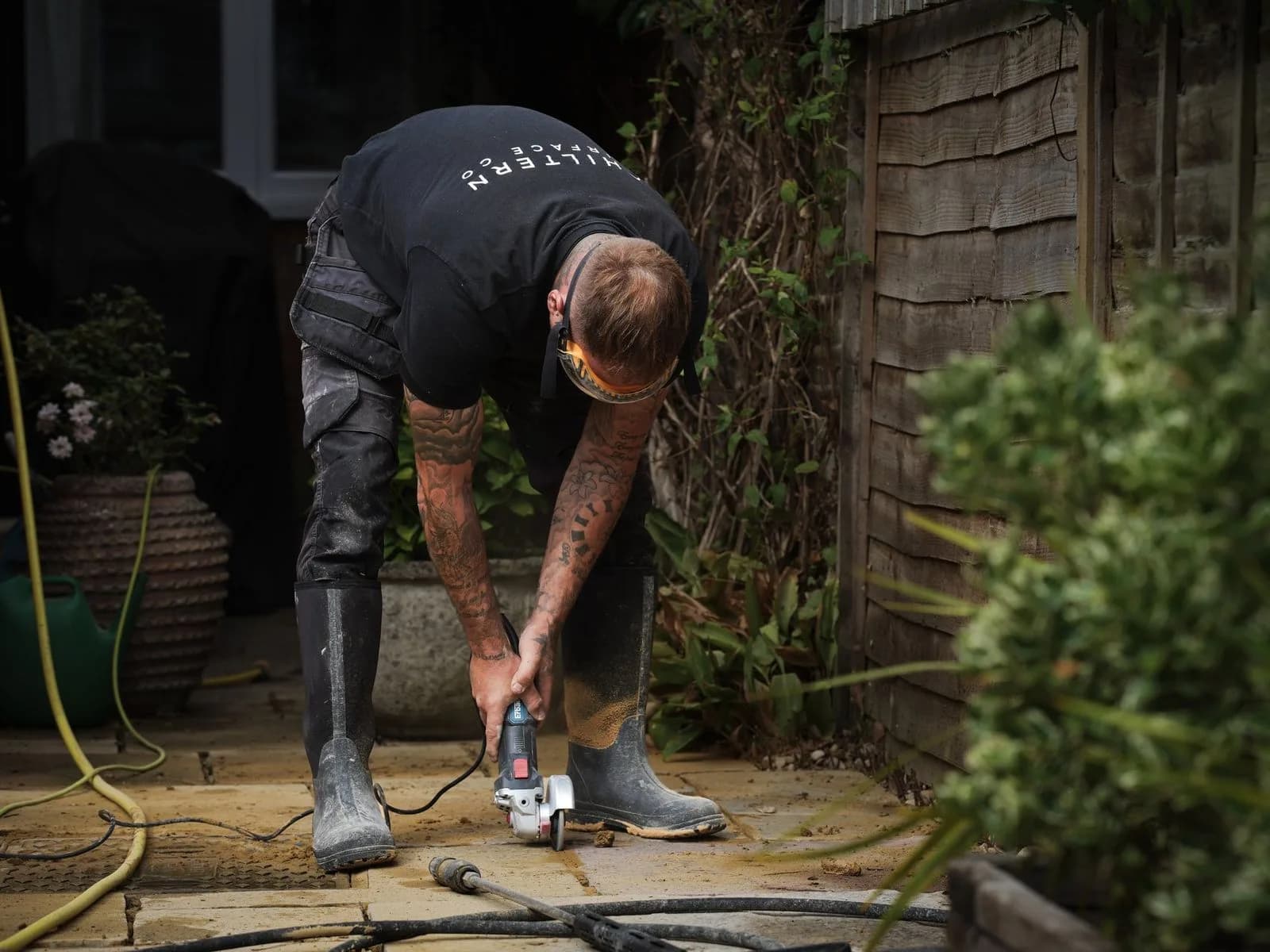 Chiltern Surface Co technician cutting out the failed jointing with an angle grinder