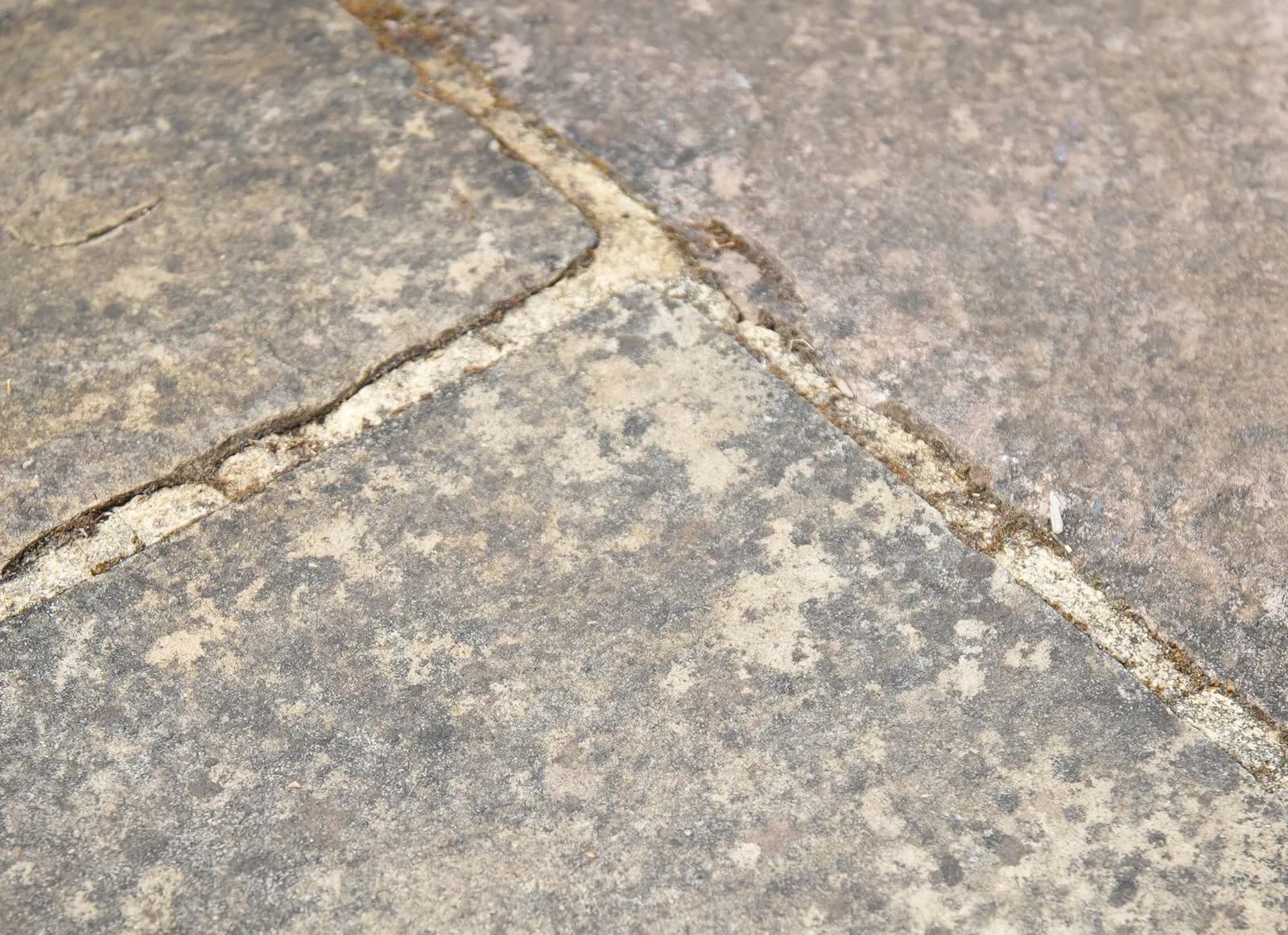 Established black spot across the sandstone and the degraded jointing around it, before cleaning