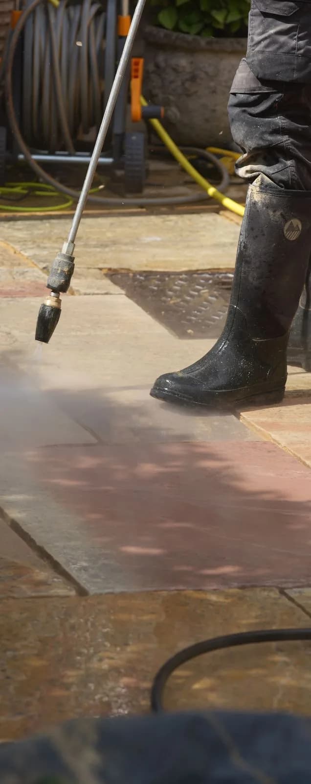 Progressive black spot treatment being rinsed from the natural sandstone
