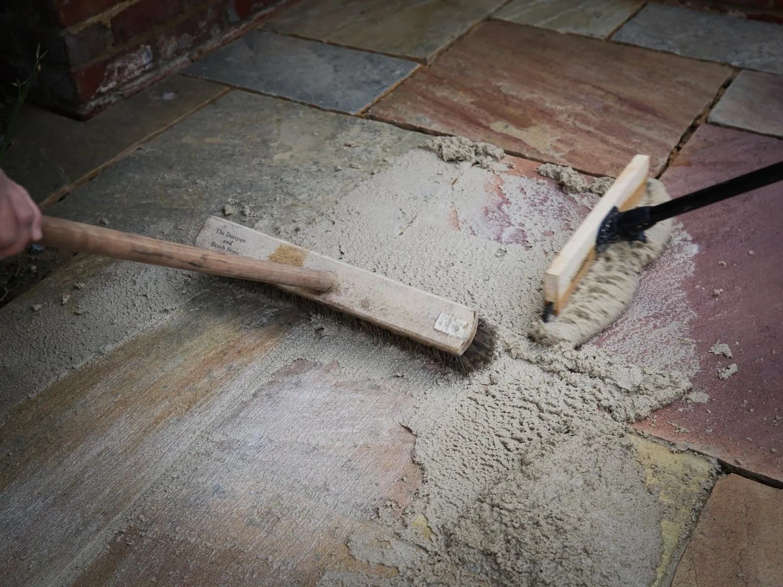 Resin jointing compound brushed into the joints of the sandstone patio