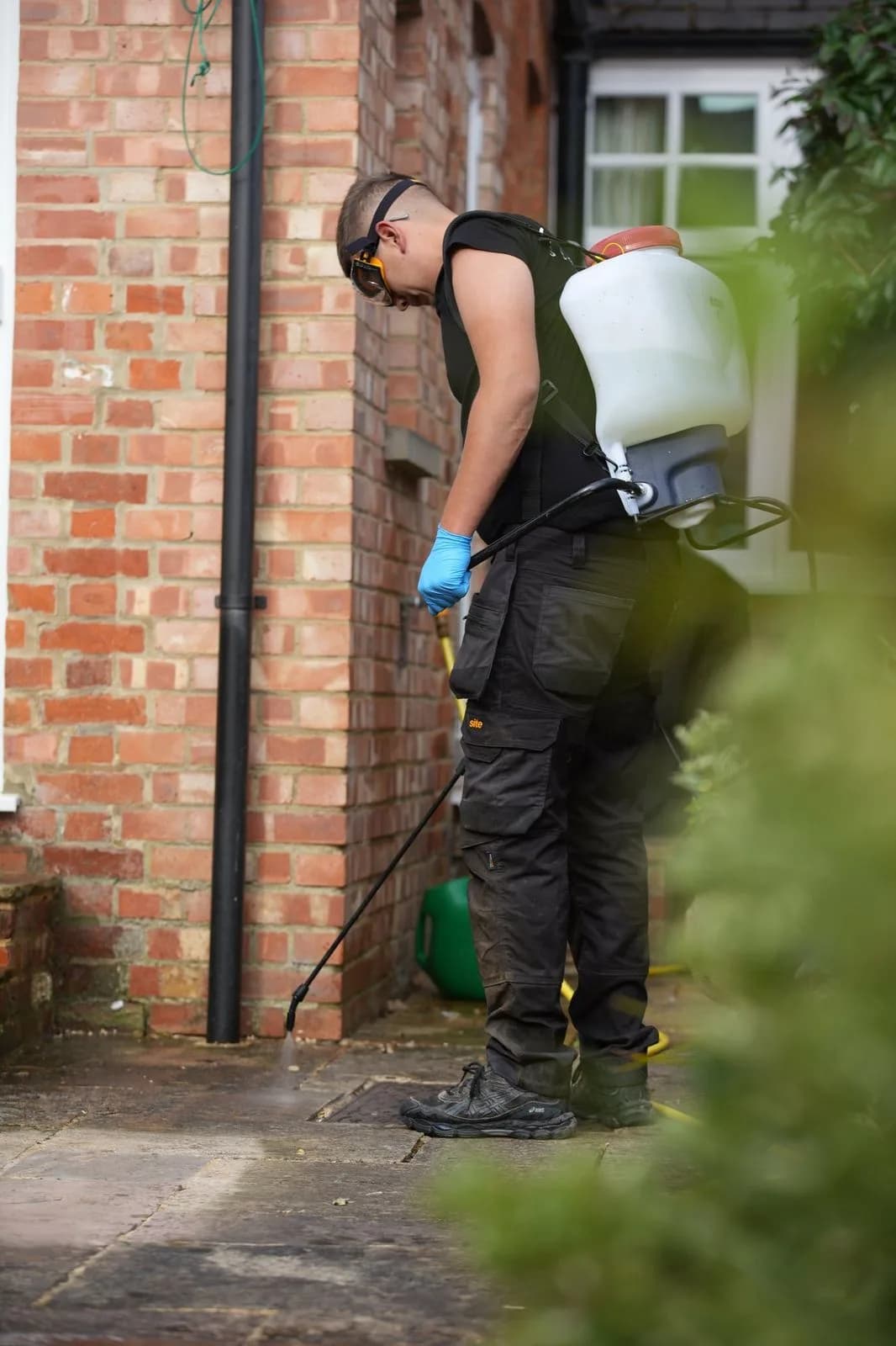 Chiltern Surface Co technician applying Chiltern EverGuard™ biocide treatment to the finished sandstone patio in Oxford