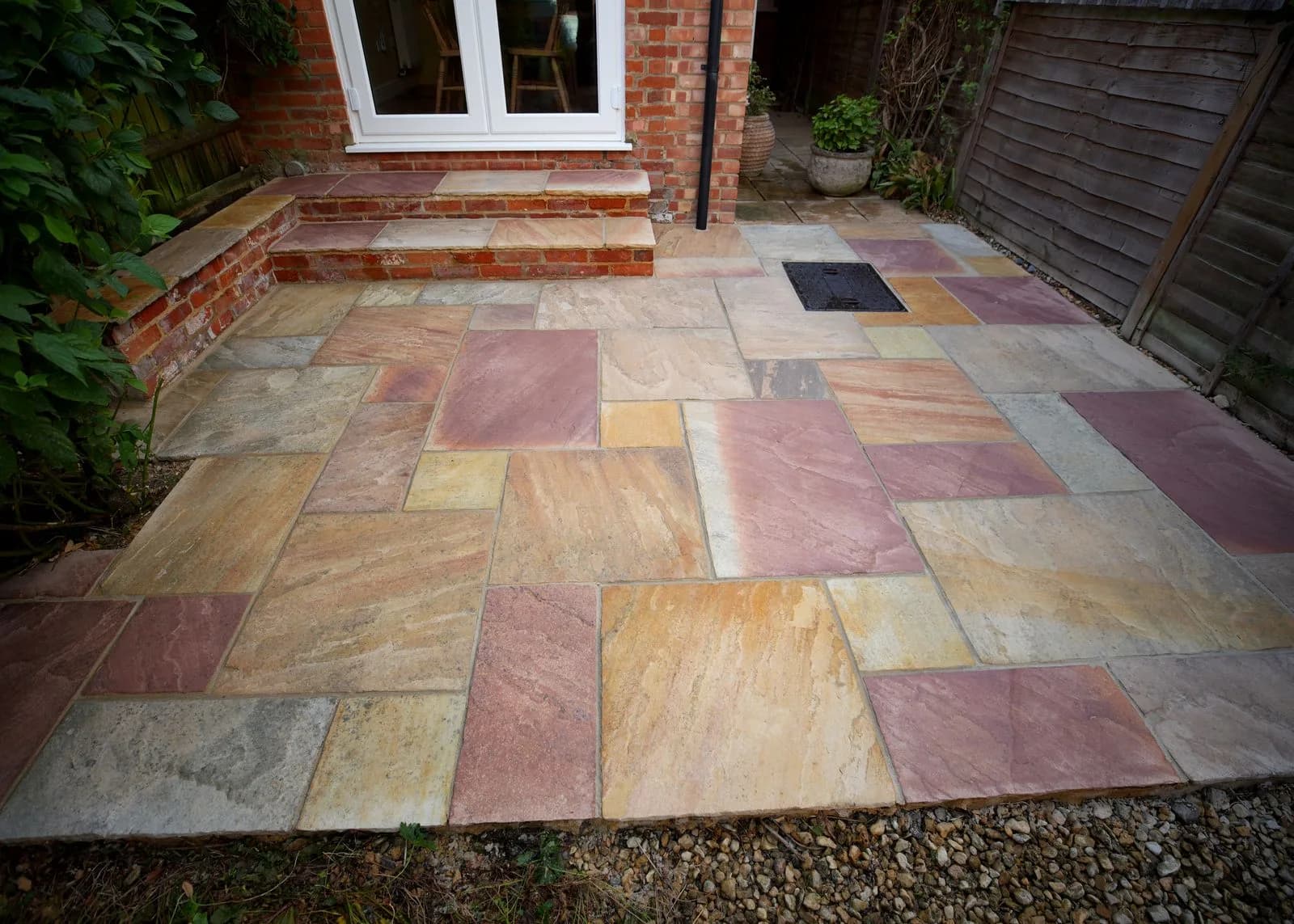 Cleaned sandstone patio and brick steps by the back door after repointing in Oxford