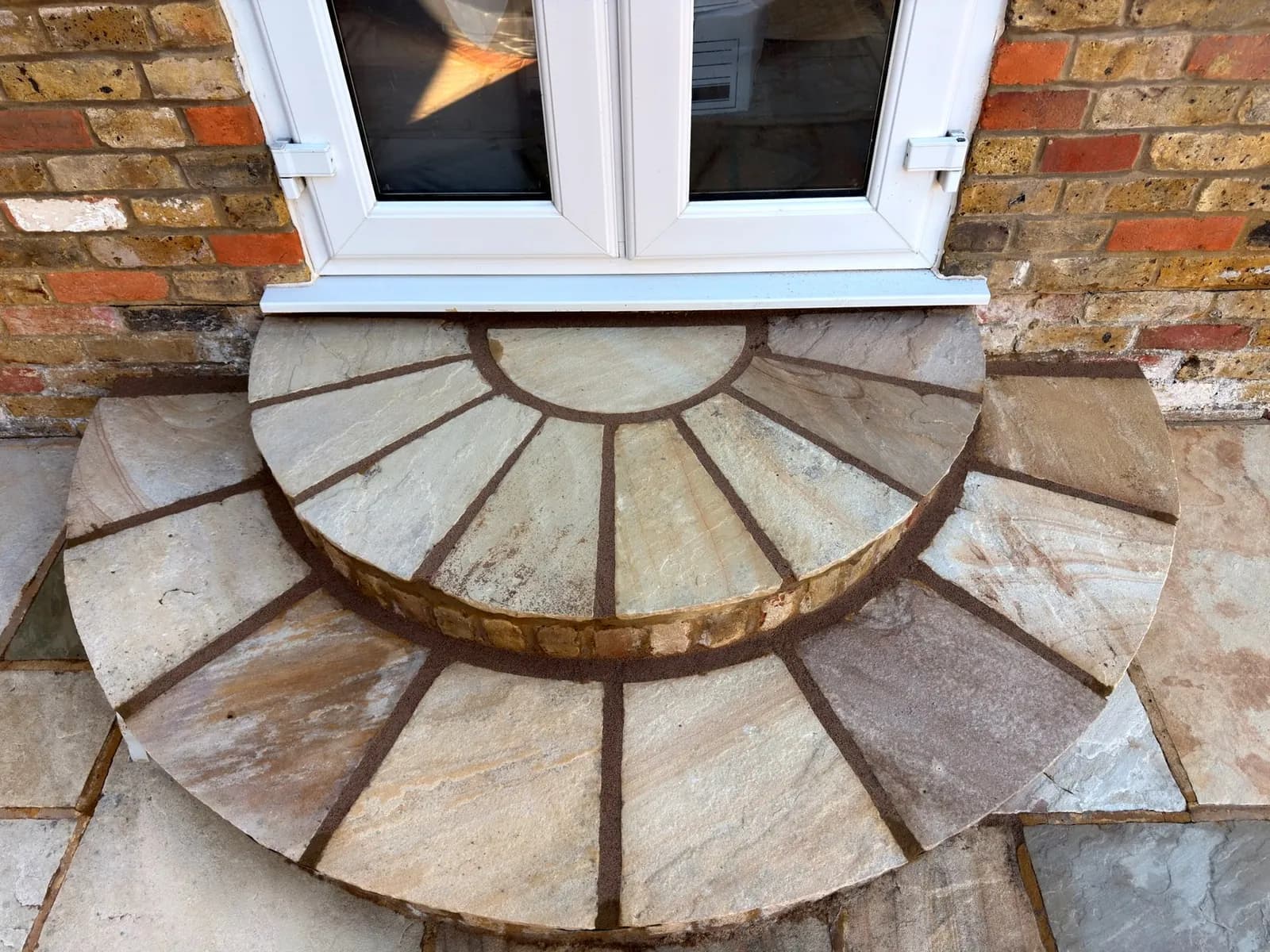 The semicircular sandstone back steps after every slab was lifted, relaid and repointed