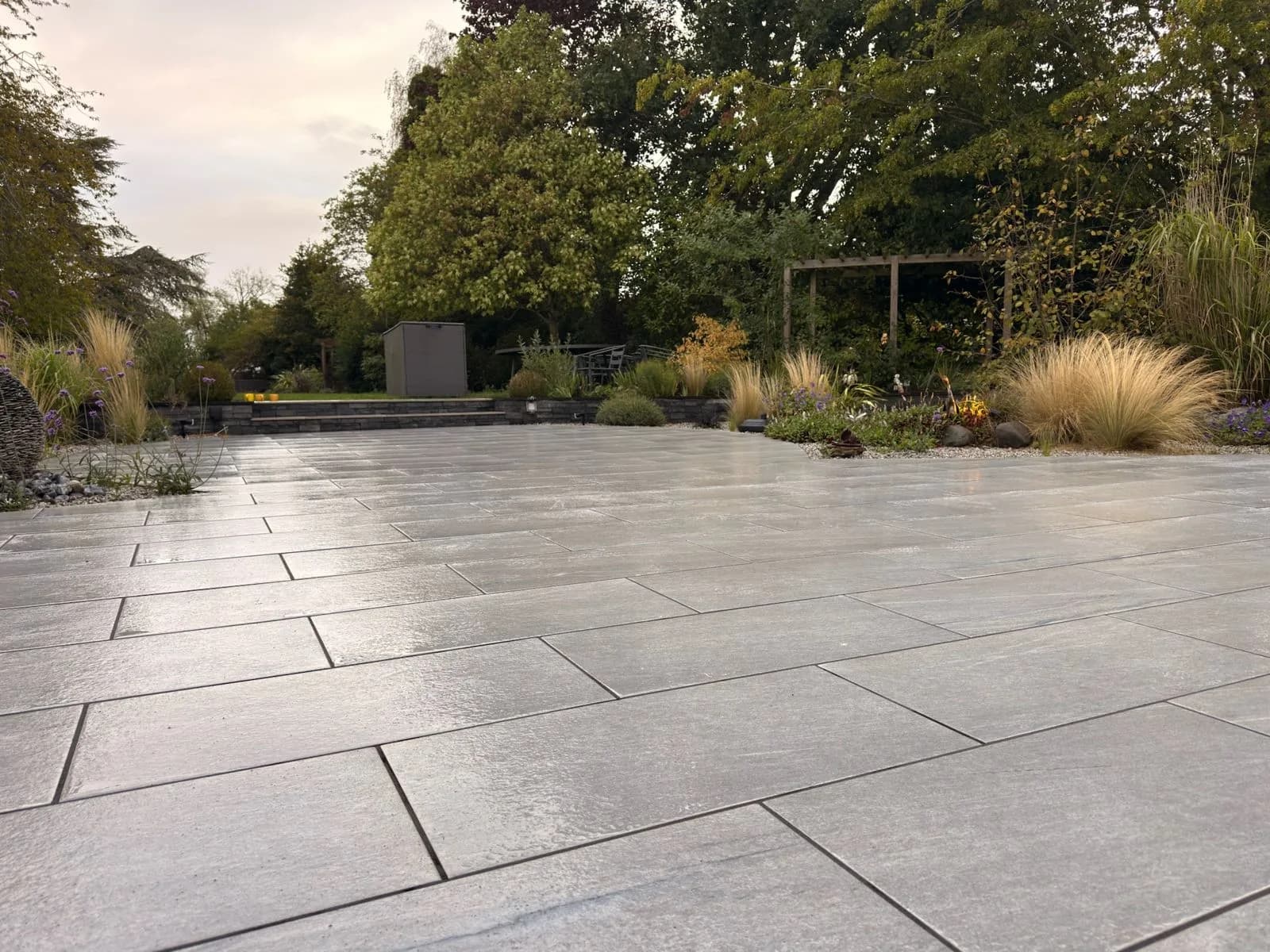 The same porcelain patio after deep cleaning and re-jointing, photographed from the same position