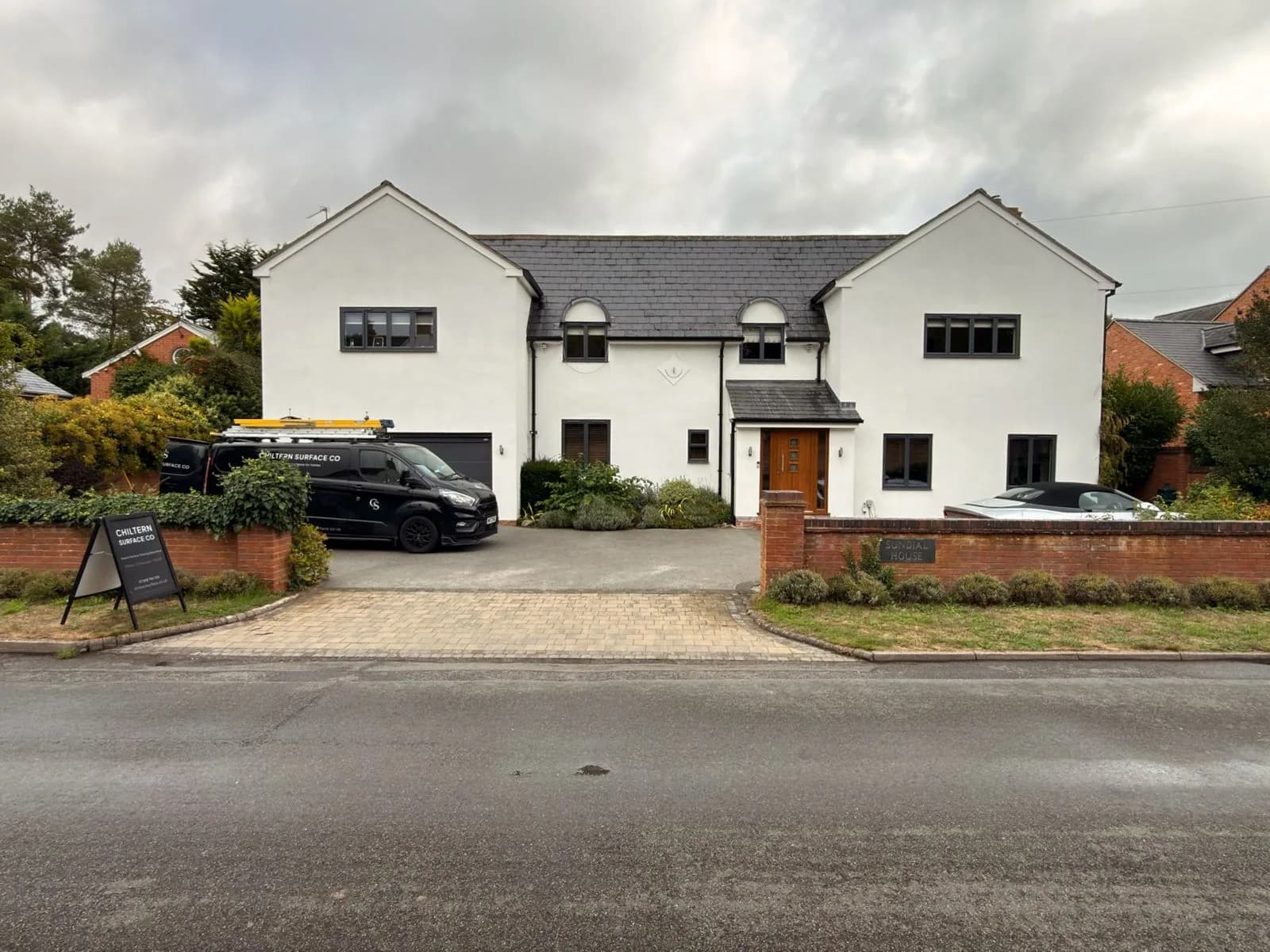 The front of the rendered house in Stratford-upon-Avon with the Chiltern Surface Co van on the drive before the soft wash