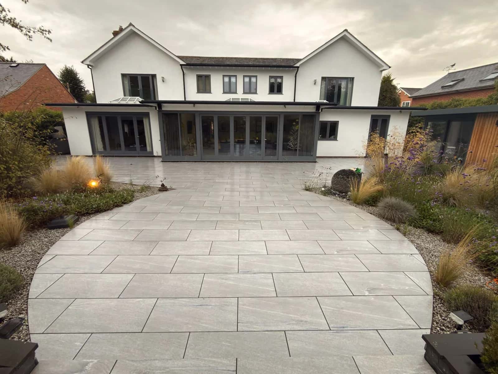 The rendered house and porcelain patio in Stratford-upon-Avon after soft washing and restoration, photographed from the same position as the cover