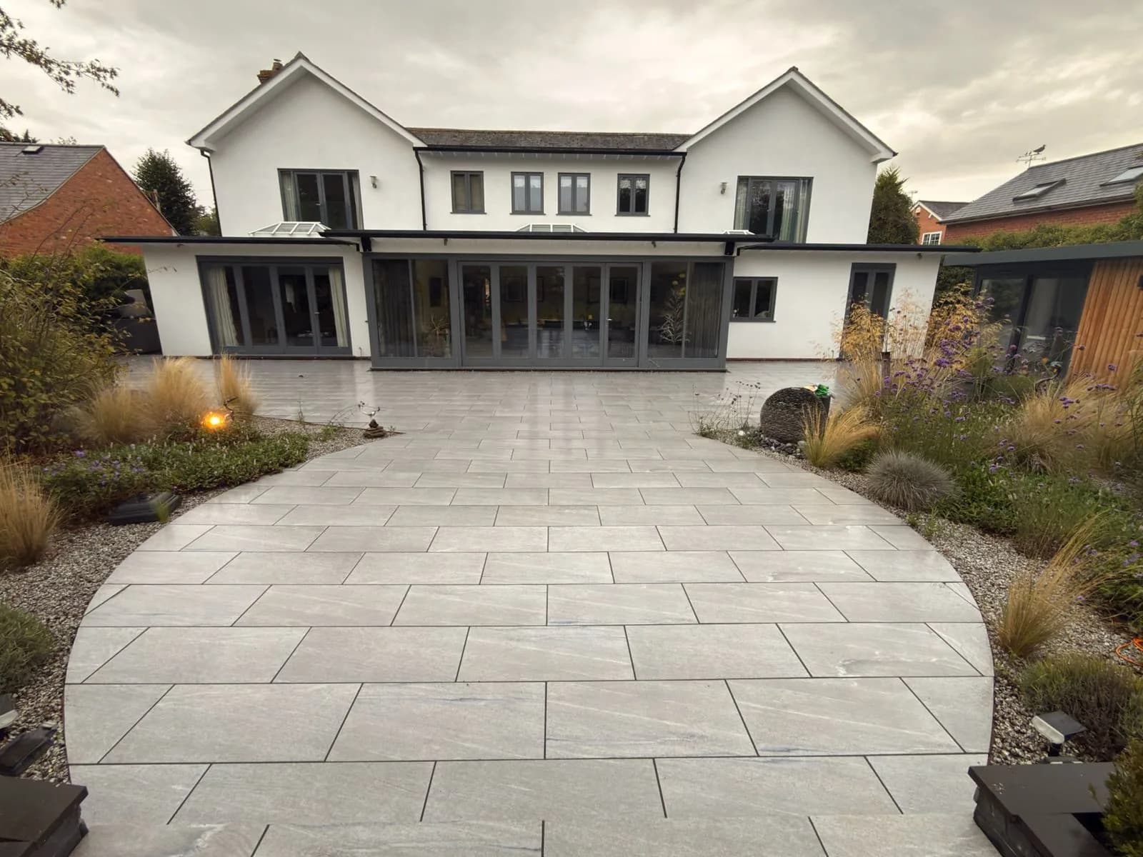 The rendered house and porcelain patio in Stratford-upon-Avon after soft washing and restoration, photographed from the same position as the cover