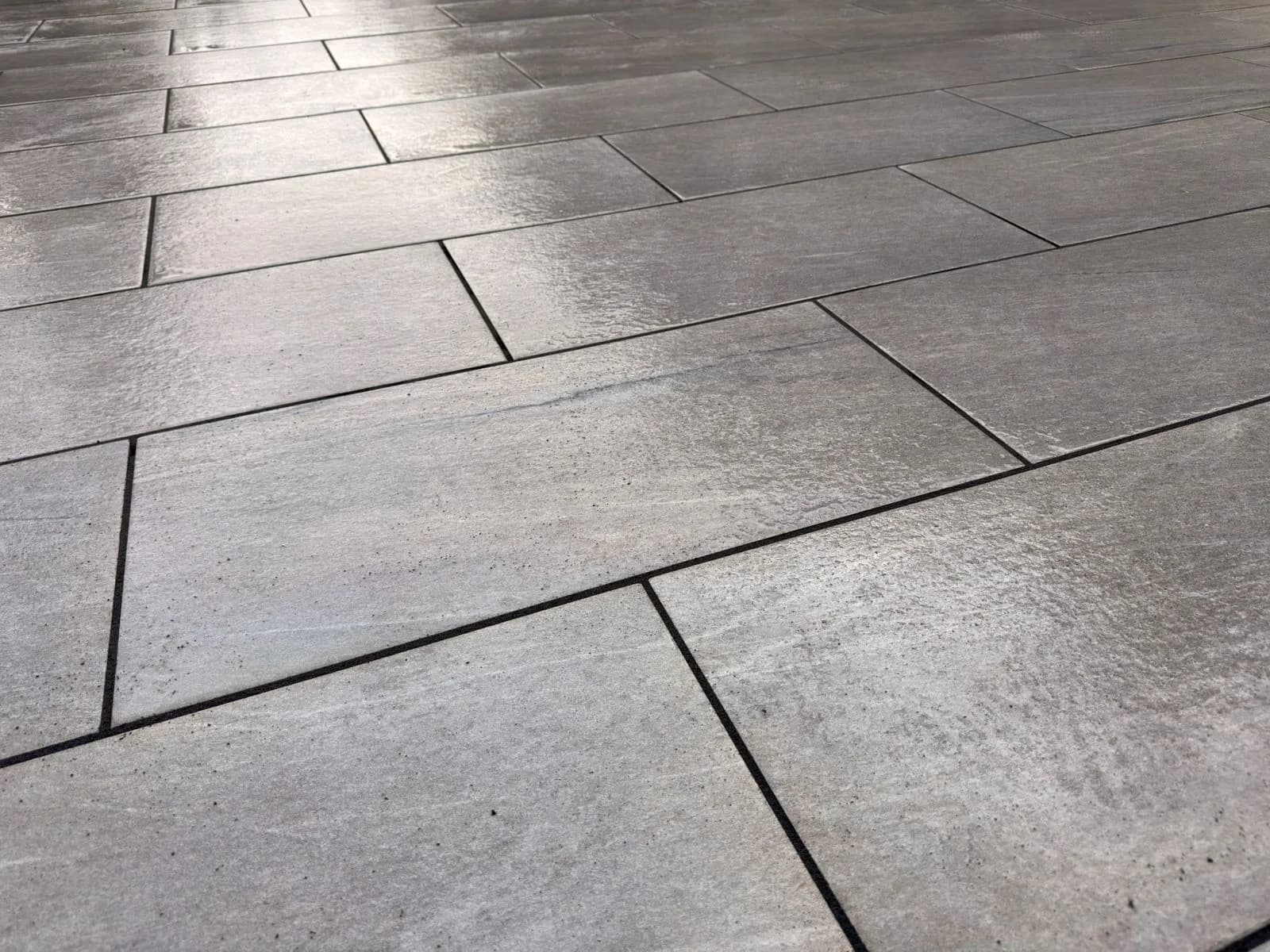 Tight close-up of the restored porcelain tiles and their crisp new joints